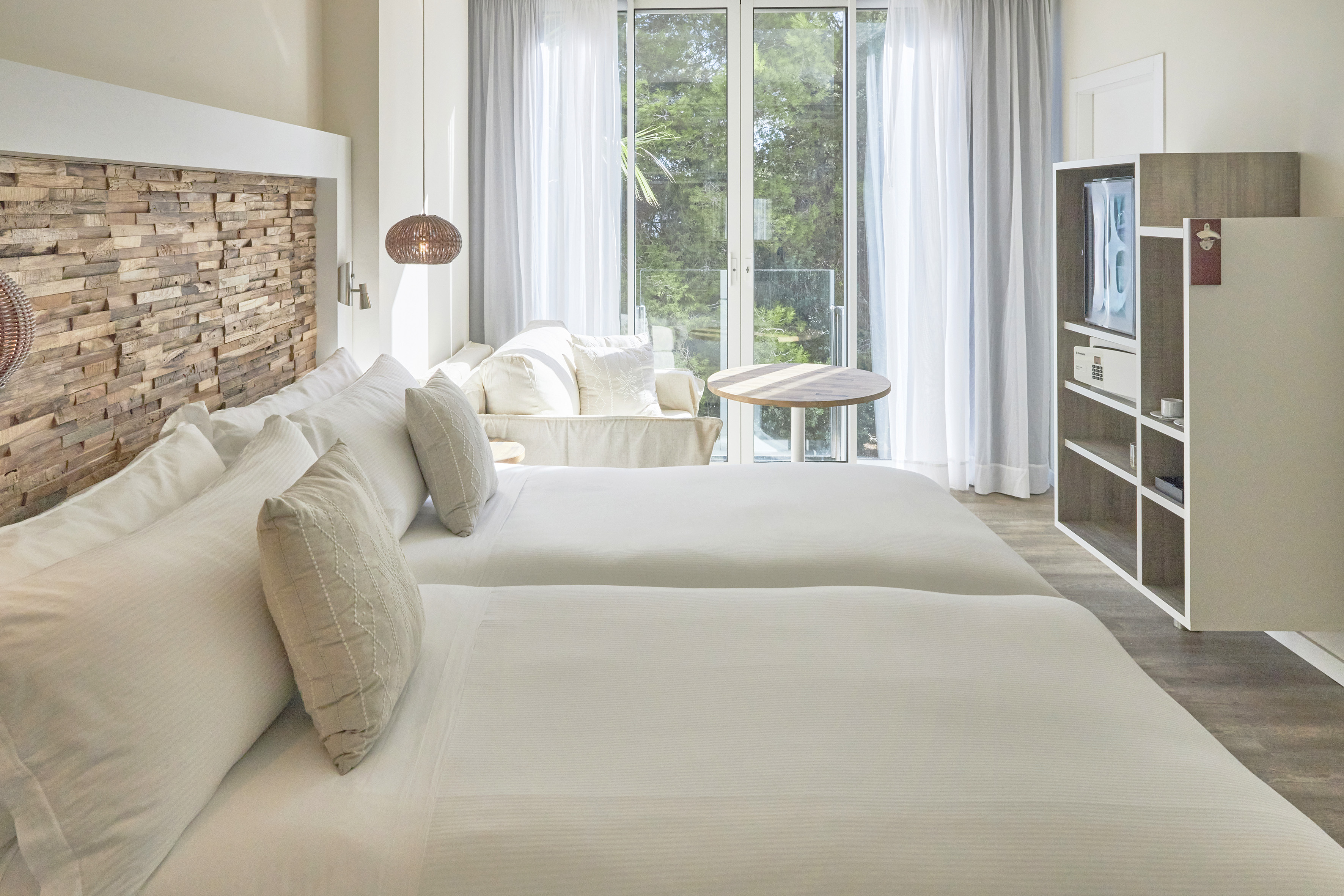 a room with two beds and a television