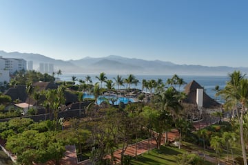 a resort with a pool and mountains in the background