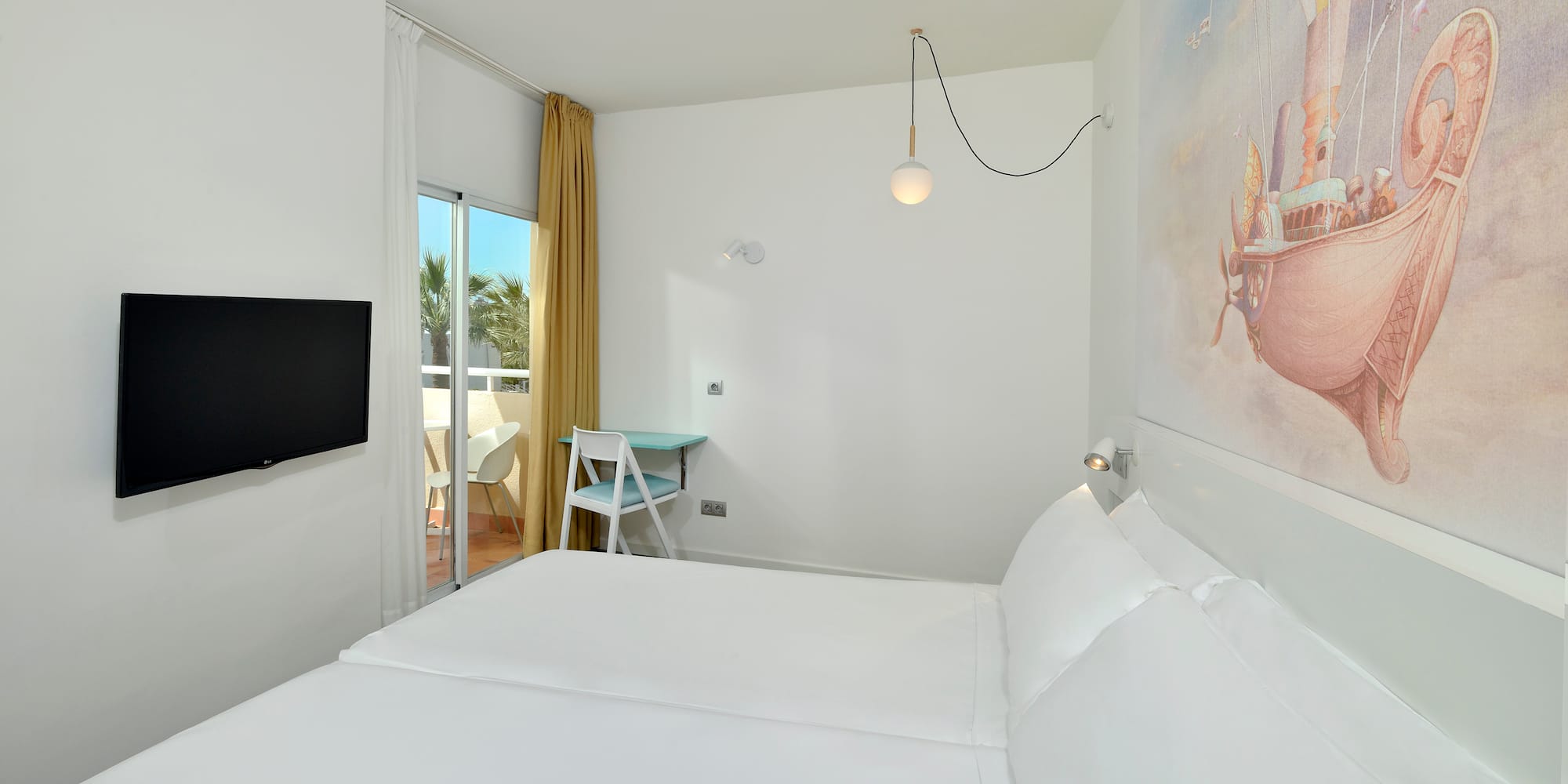 a room with a bed and a television