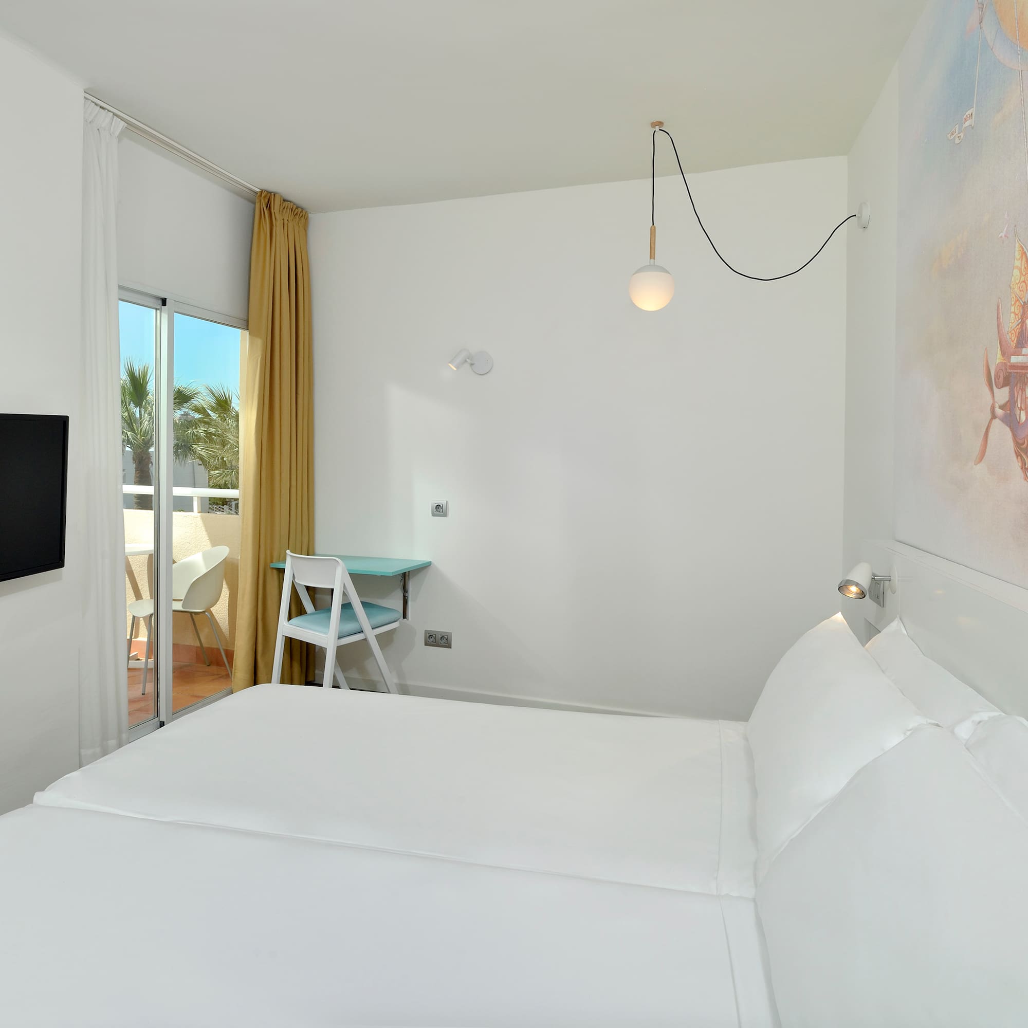 a room with a bed and a television