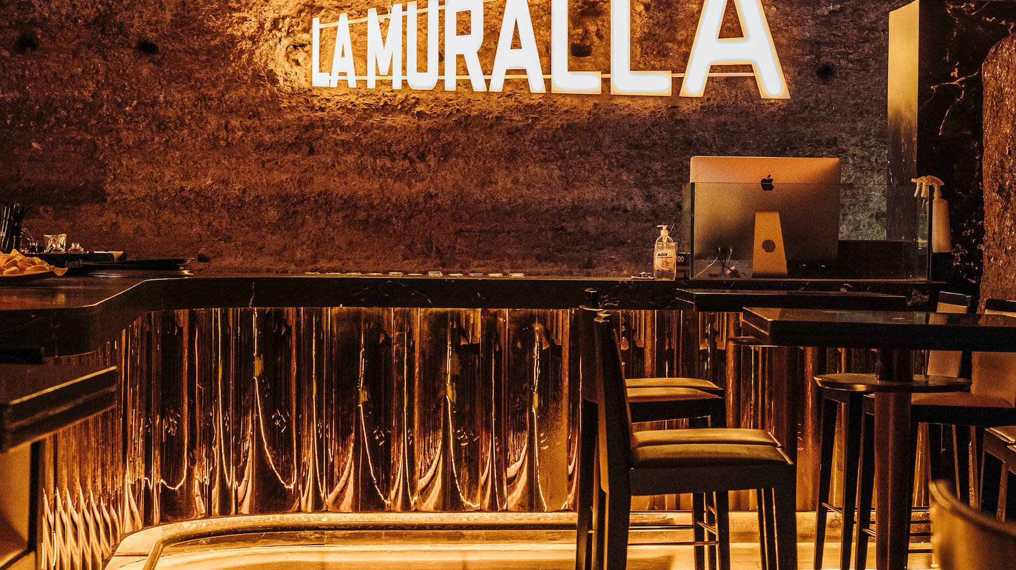 a room with a table and chairs and a sign