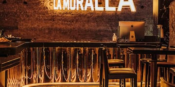 a room with a table and chairs and a sign