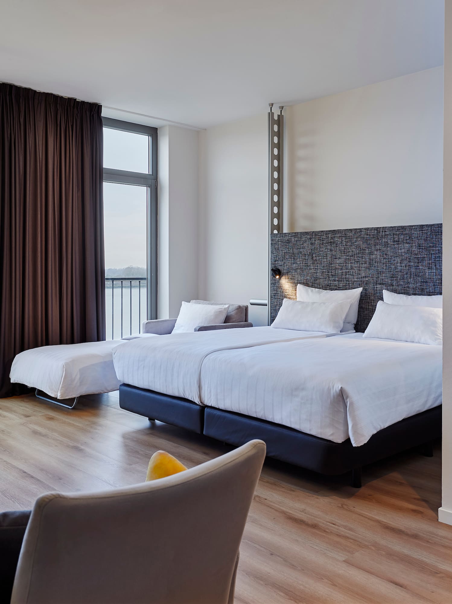 a room with two beds and a couch