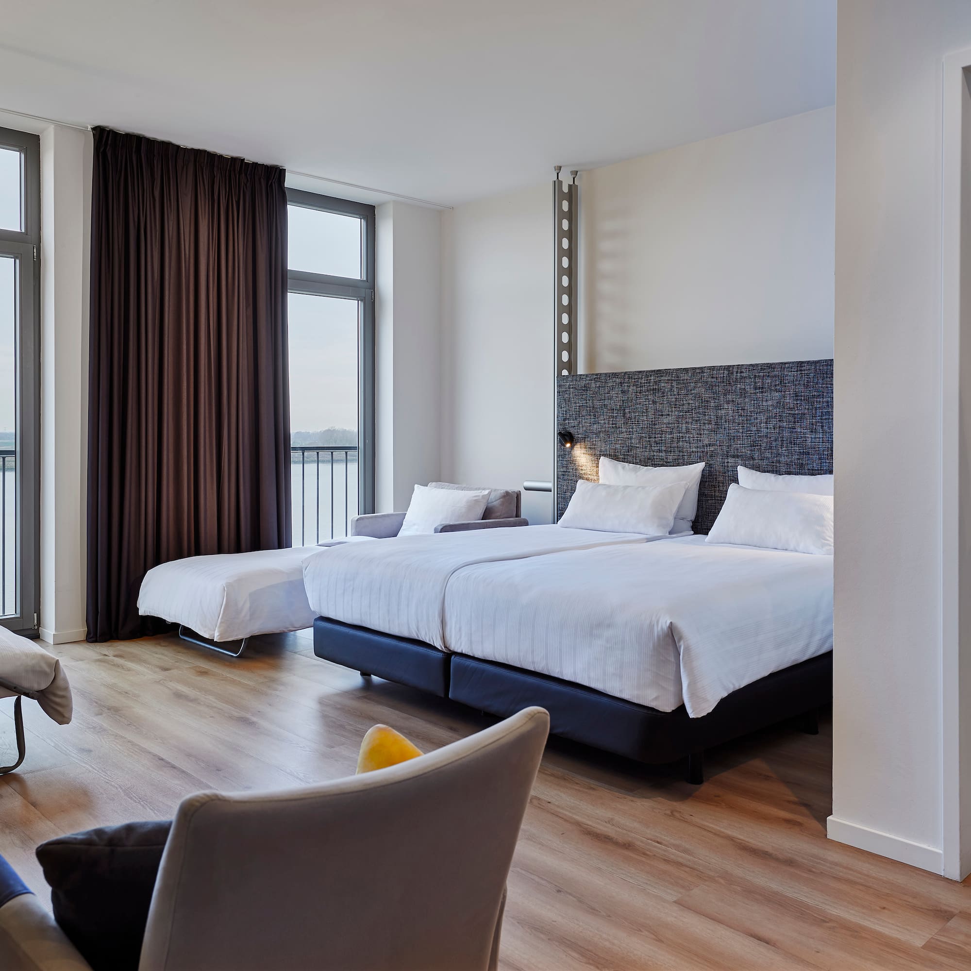 a room with two beds and a couch