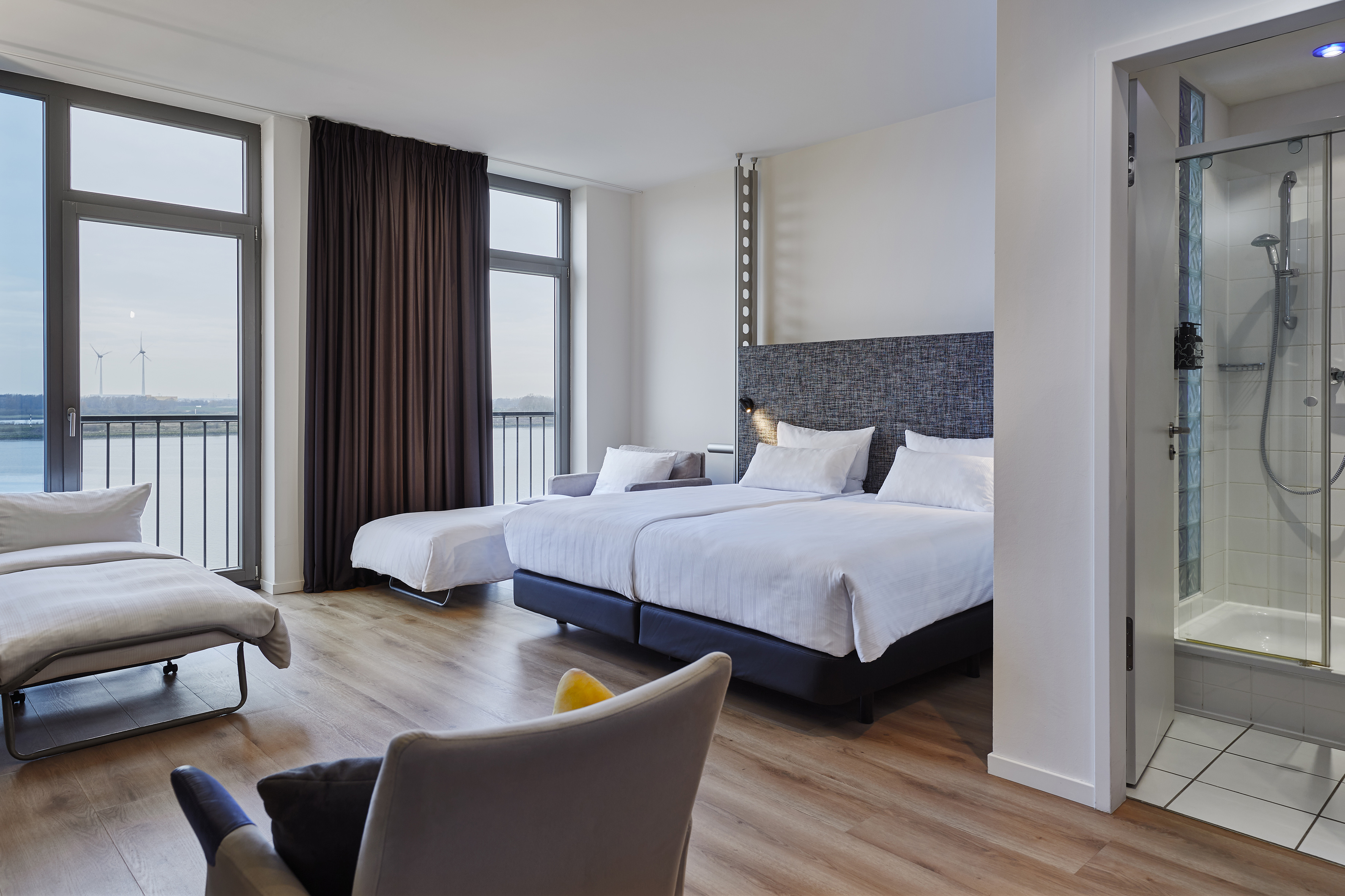 a room with two beds and a couch