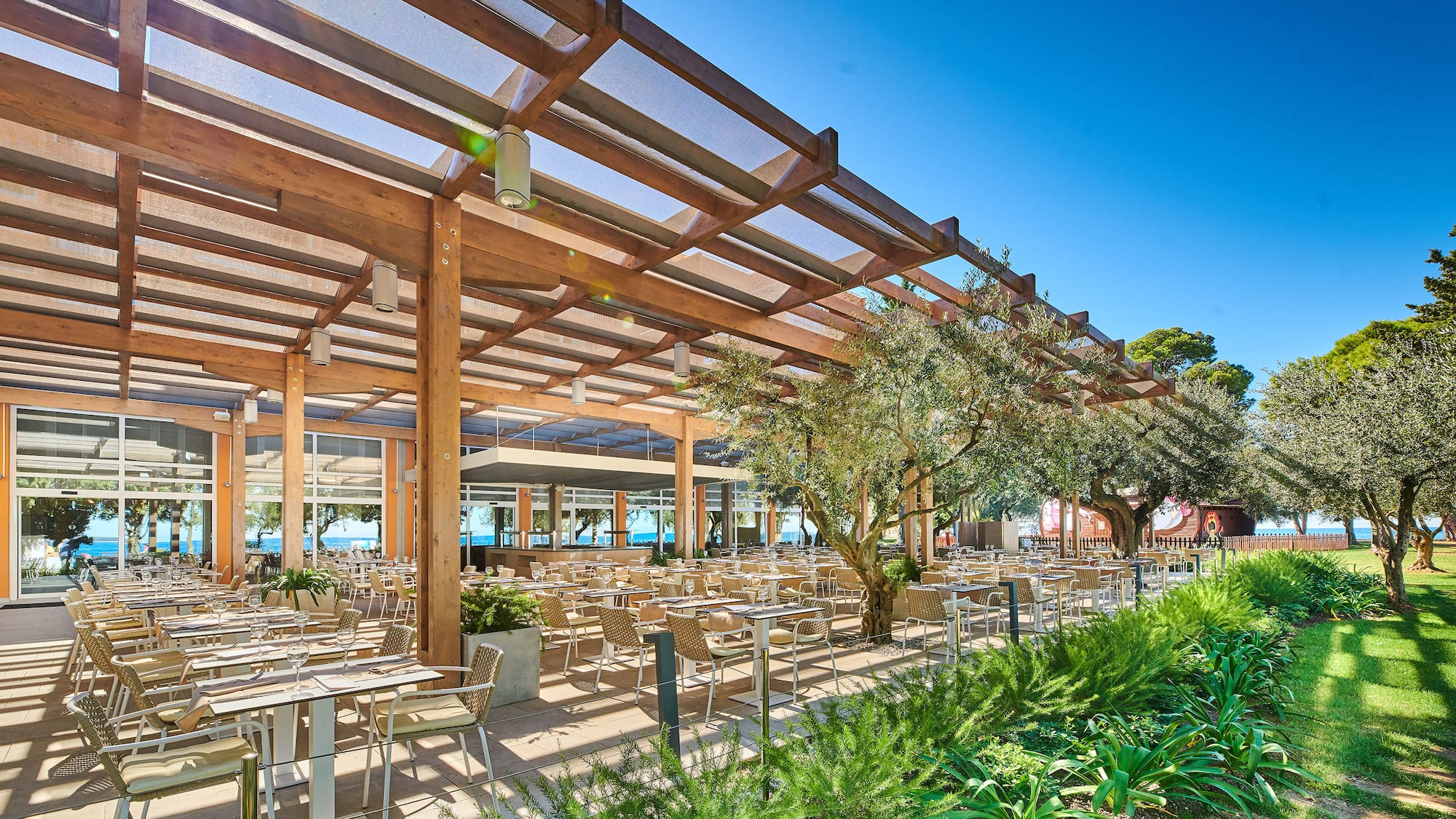 a covered patio with tables and chairs