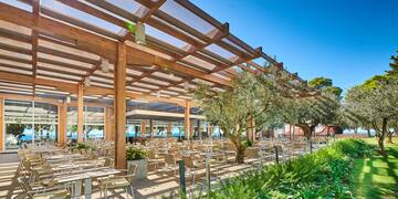 a covered patio with tables and chairs