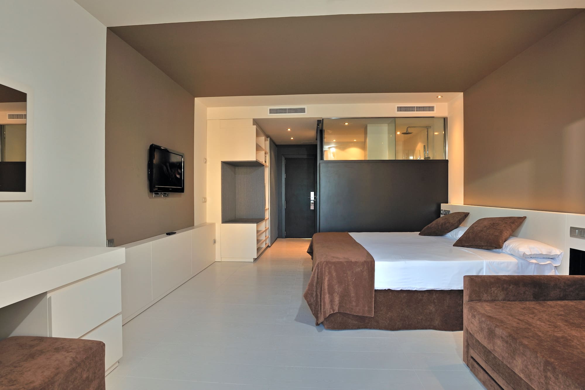 a bedroom with a bed and a television