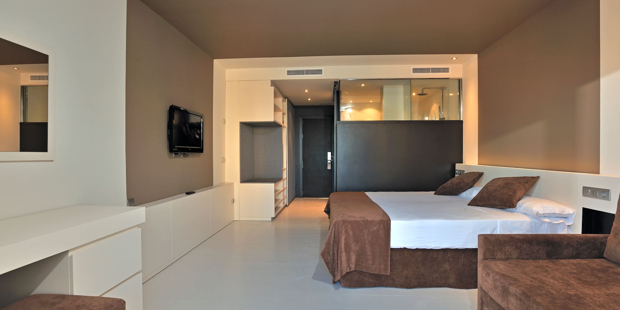 a bedroom with a bed and a television