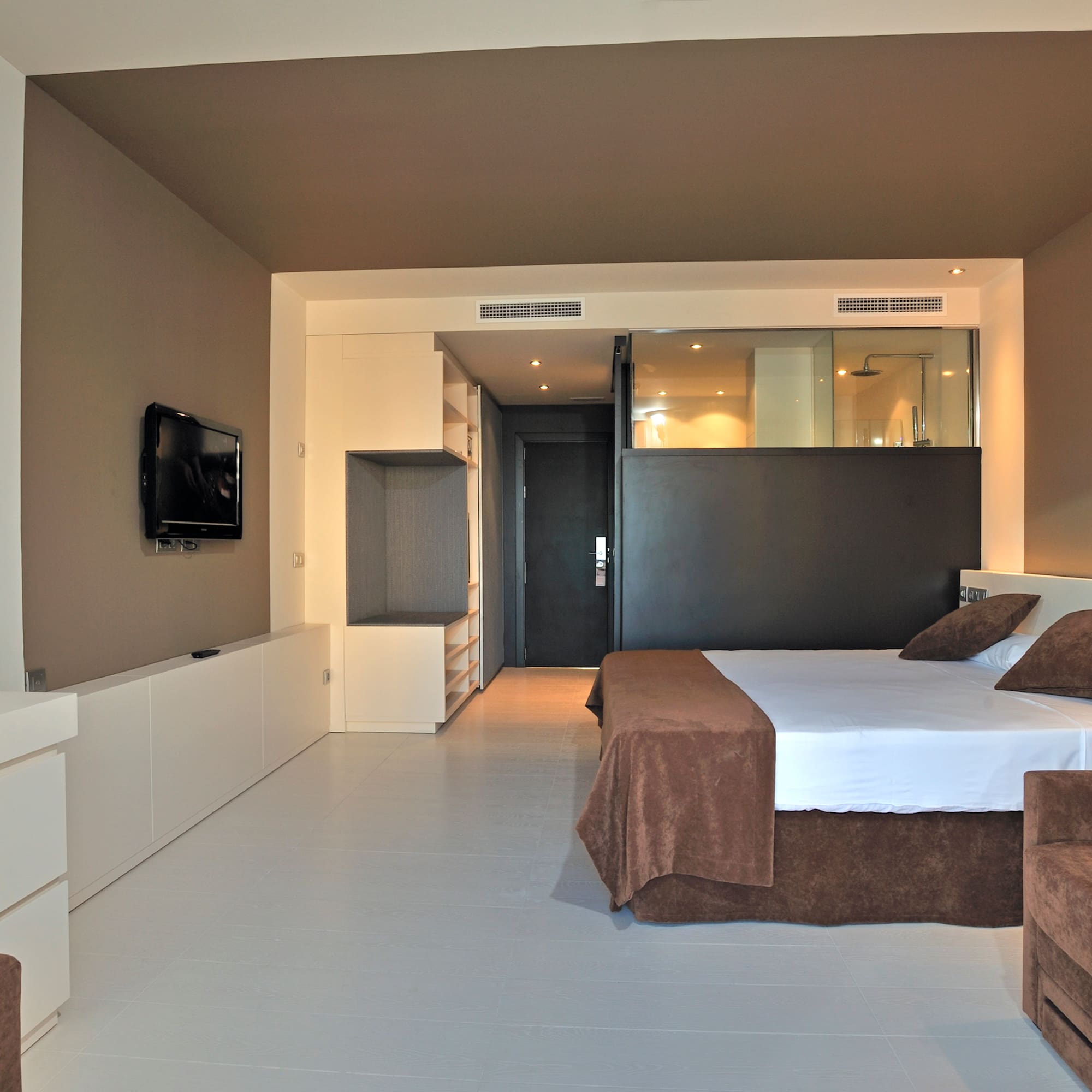 a bedroom with a bed and a television