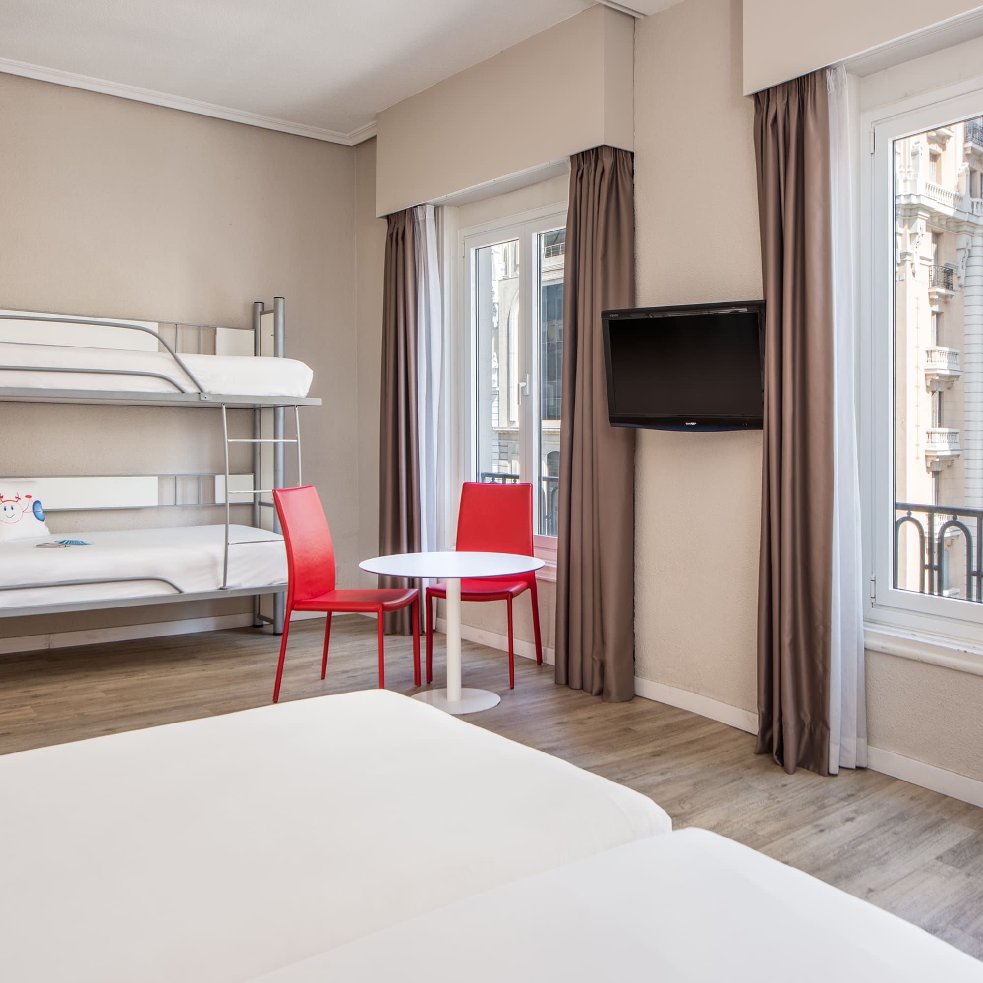 a room with bunk beds and a tv