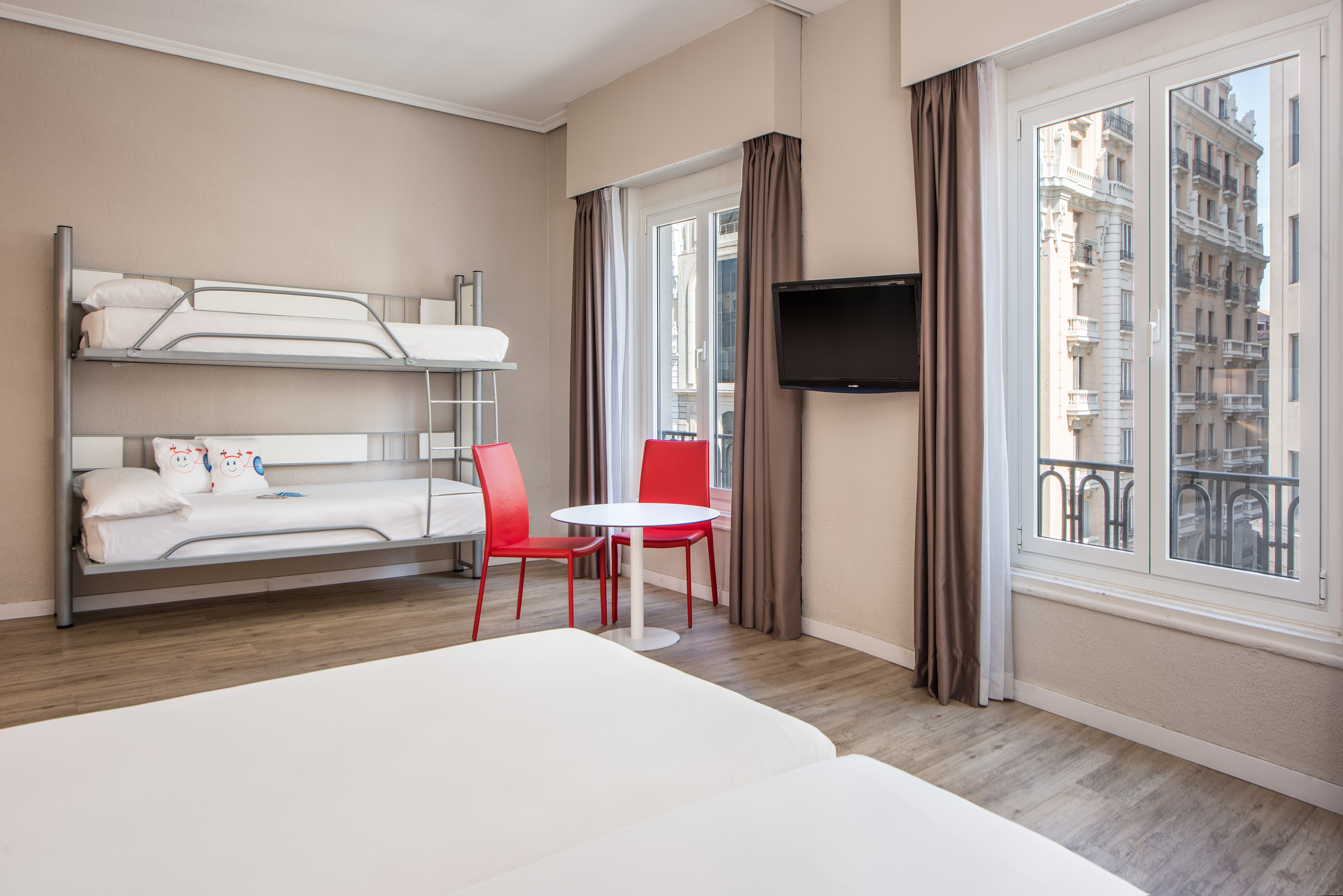 a room with bunk beds and a tv