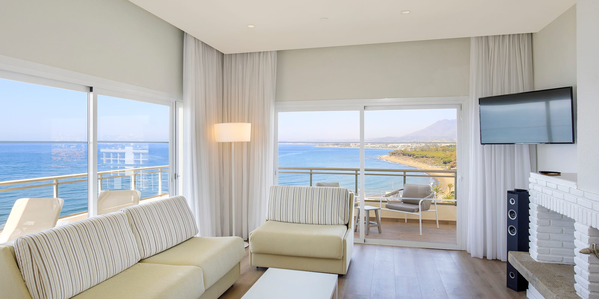 a living room with a view of the ocean