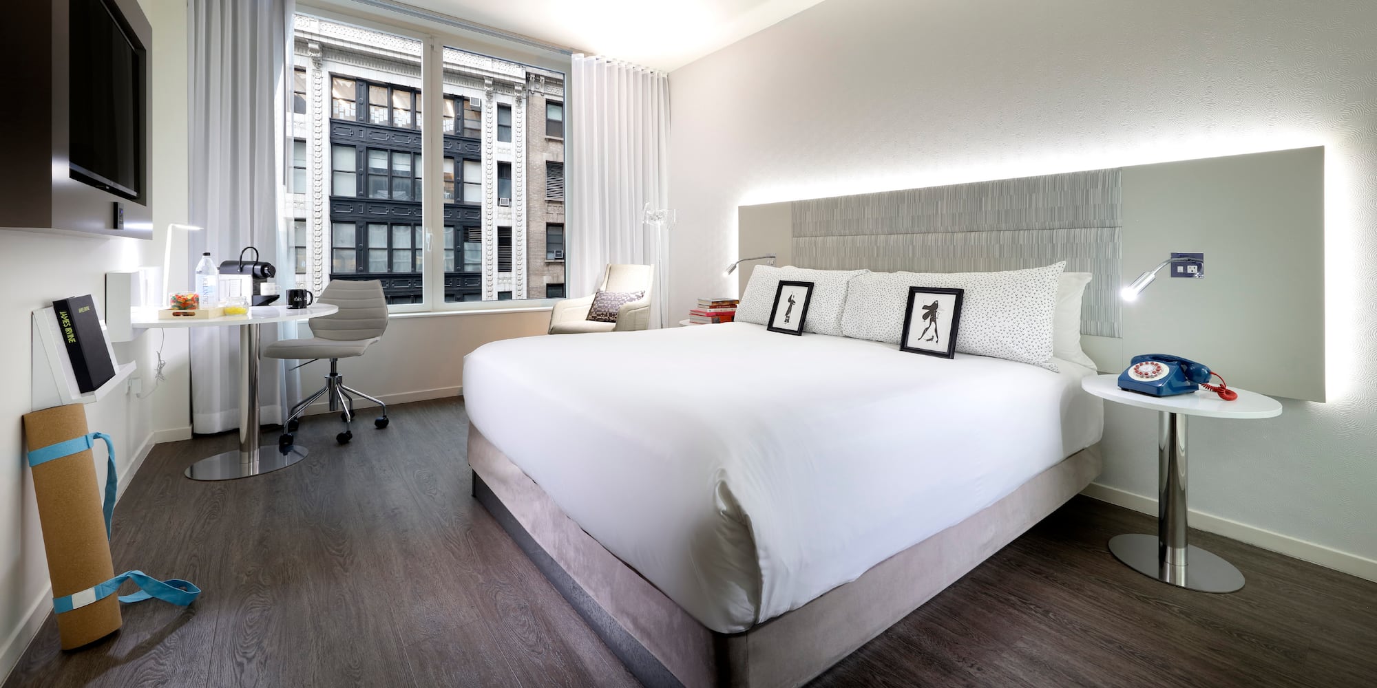 a bedroom with a large bed and a desk