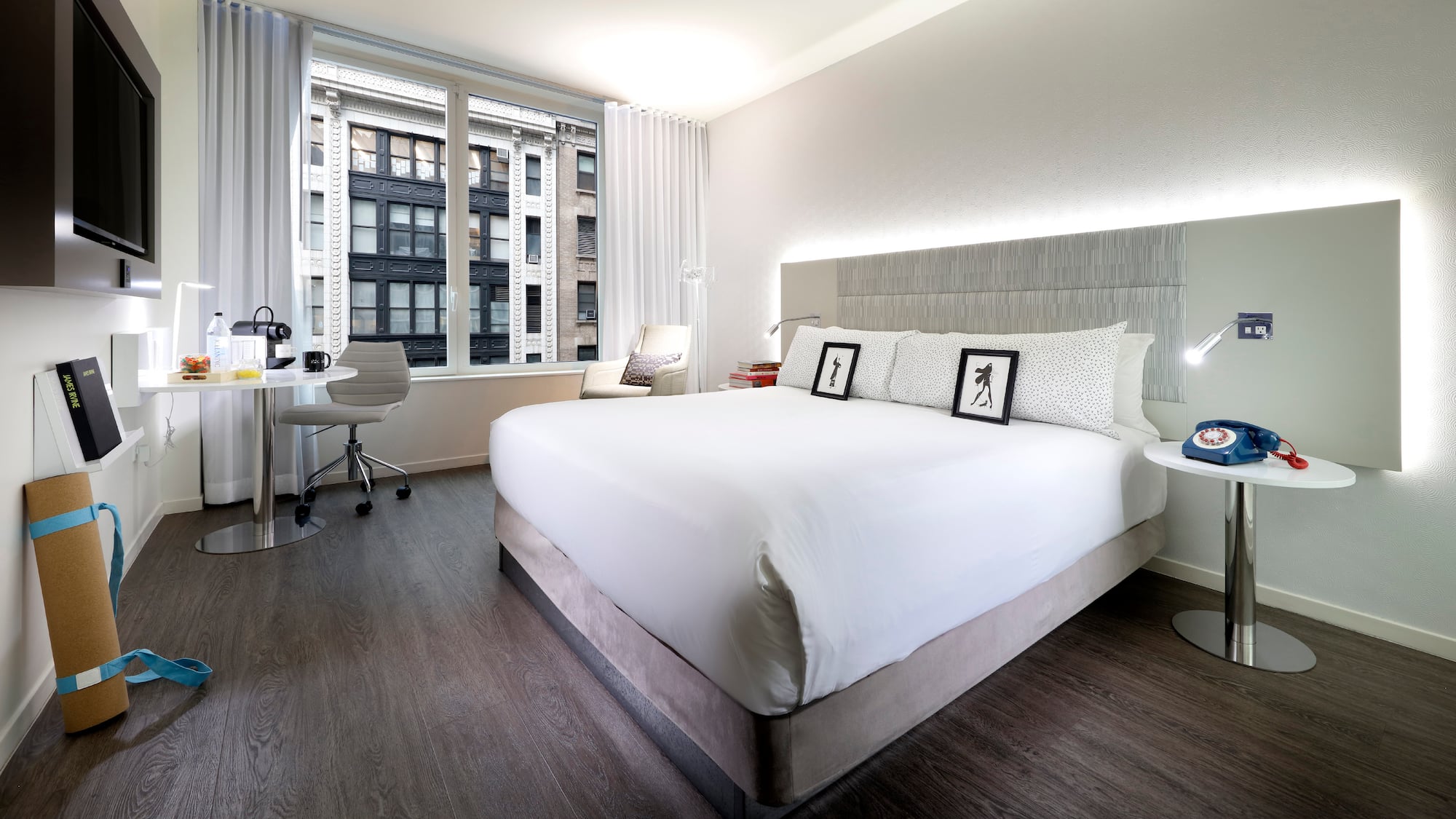 a bedroom with a large bed and a desk