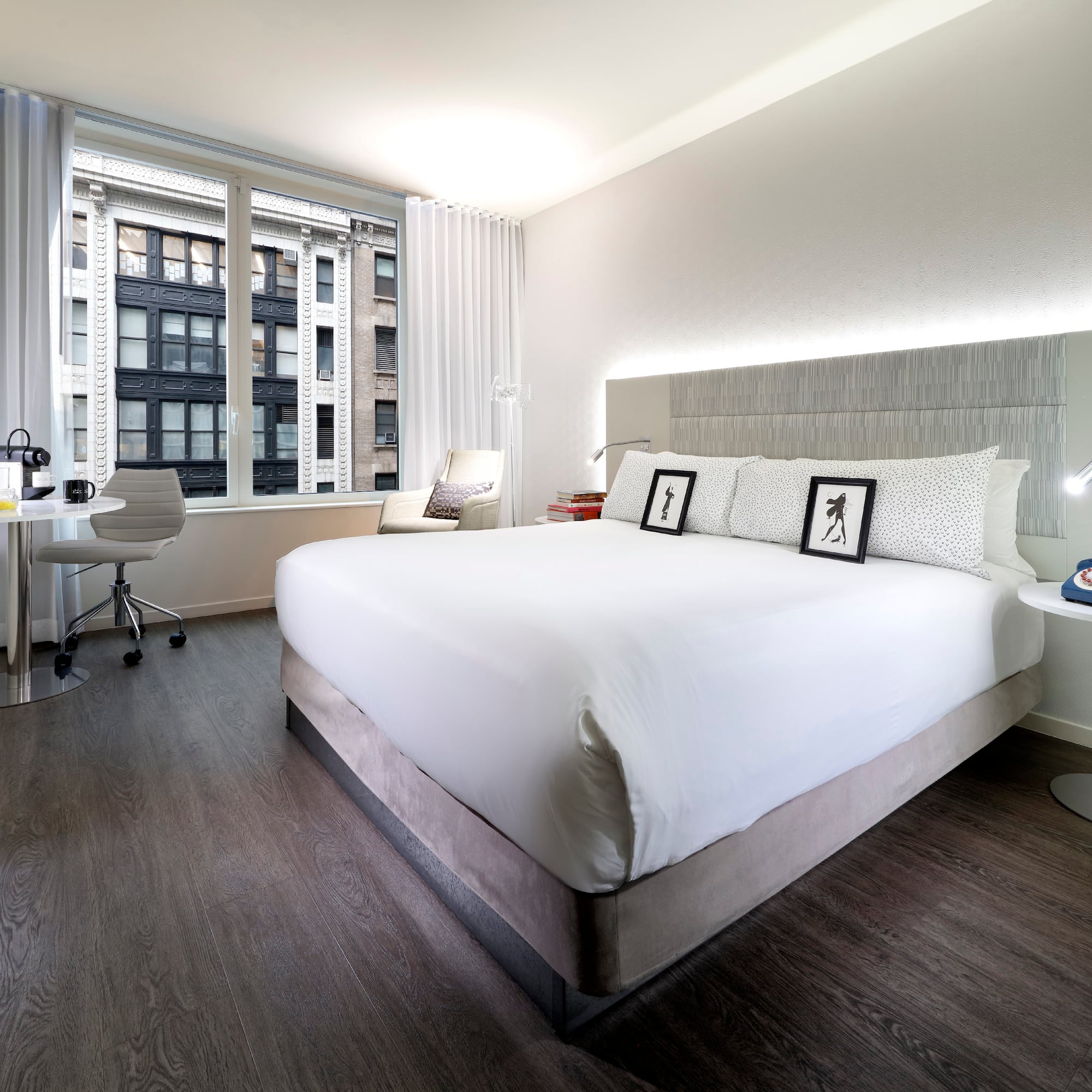 a bedroom with a large bed and a desk