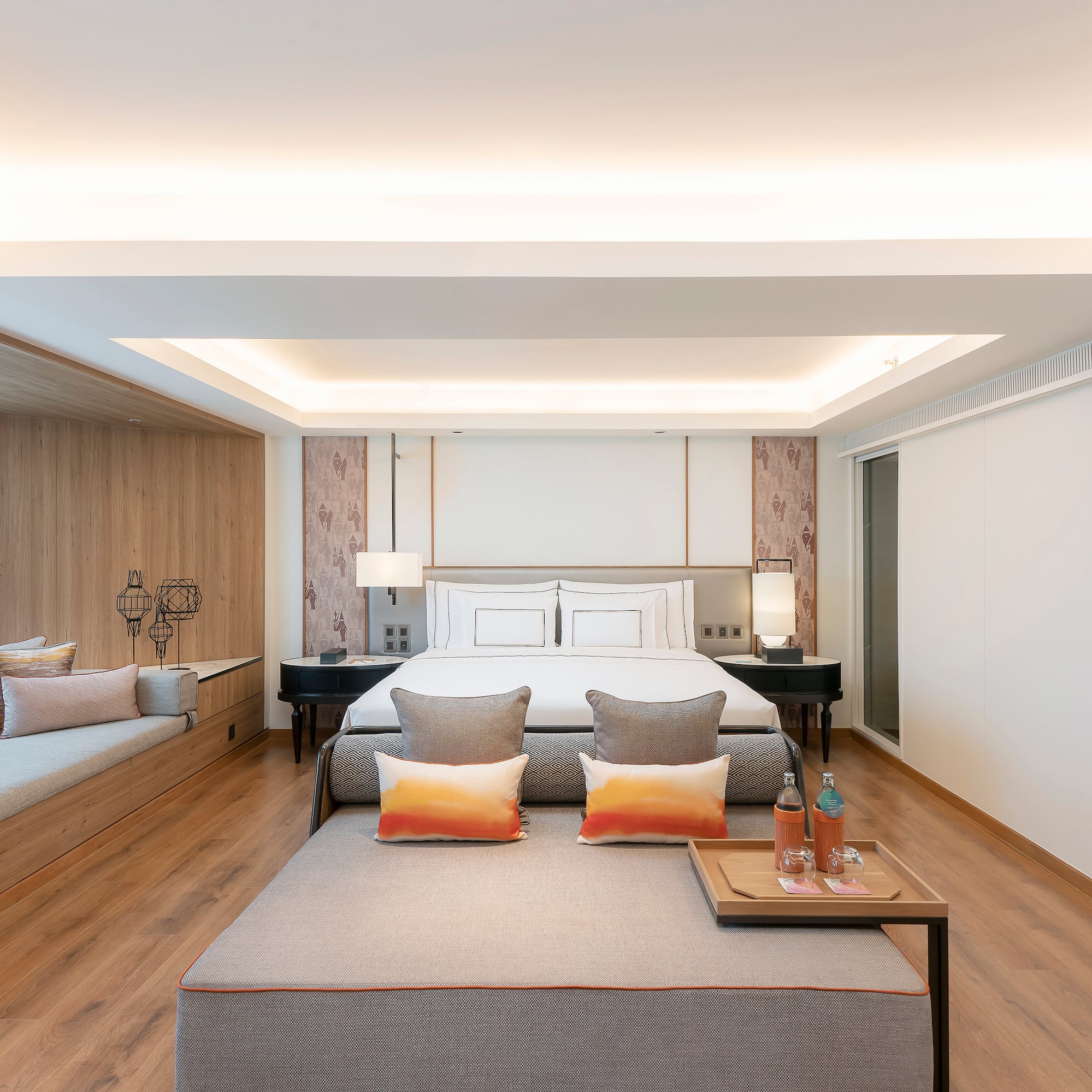 a room with a bed and two beds