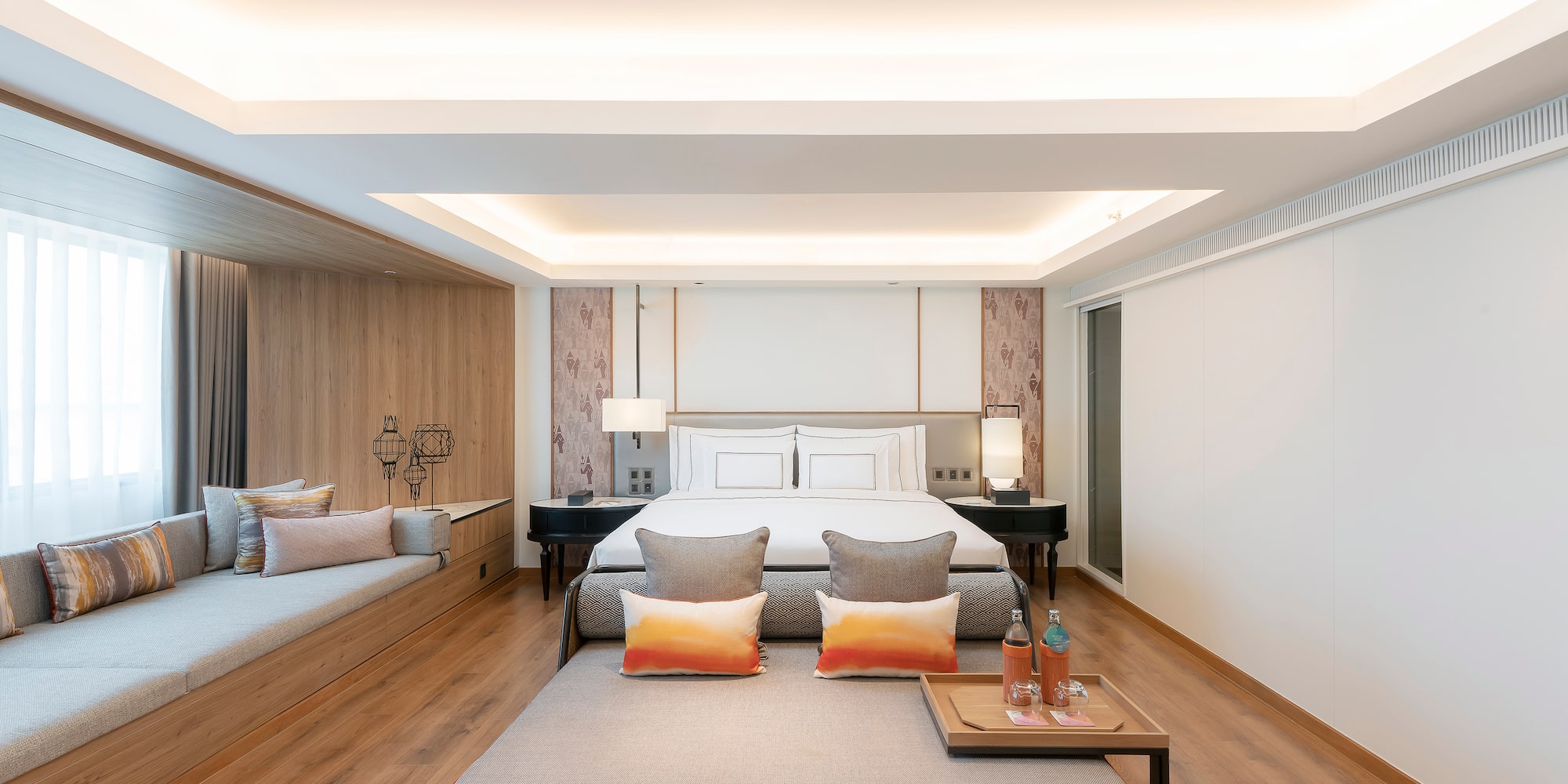 a room with a bed and two beds