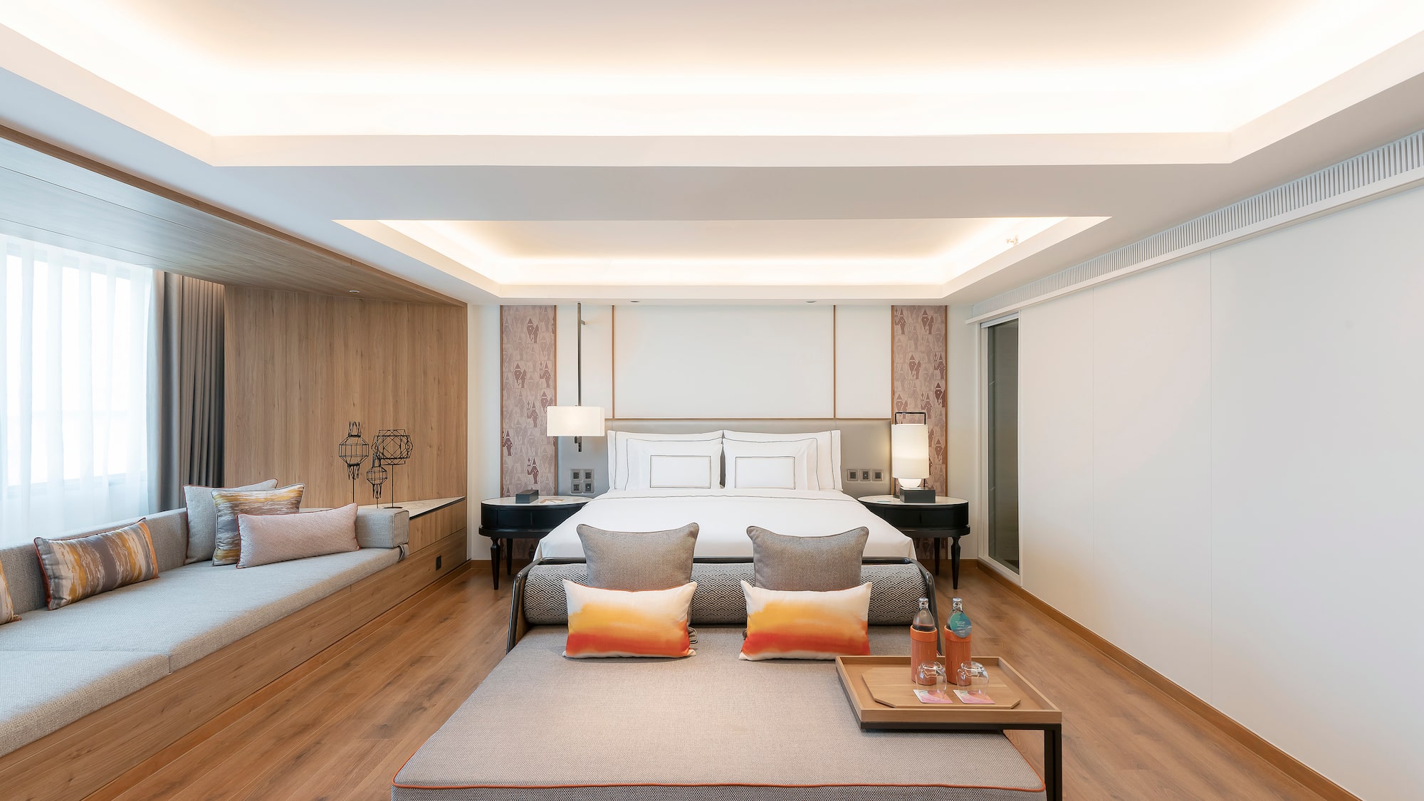 a room with a bed and two beds