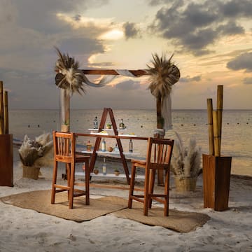 a table and chairs on a beach