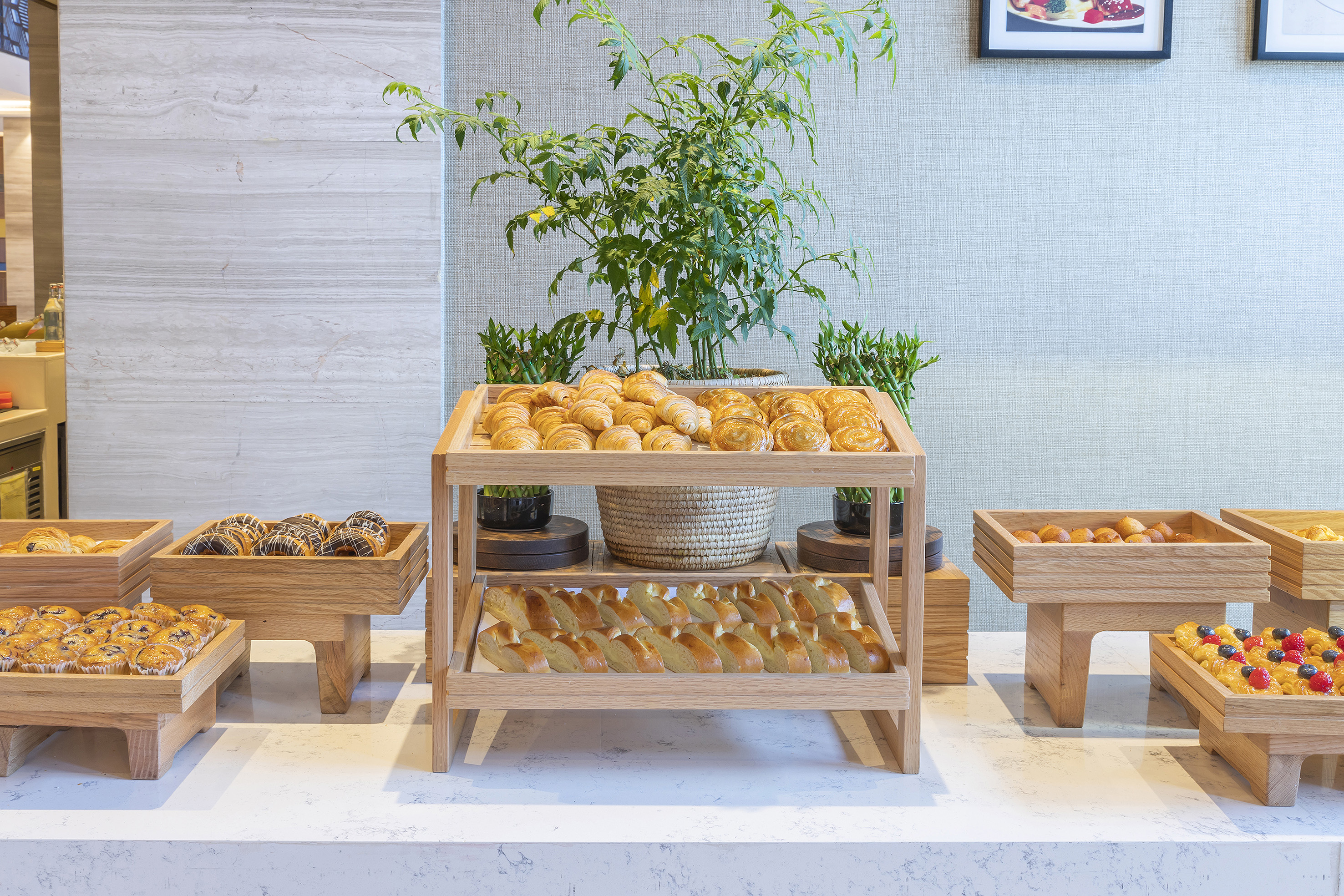 Hotel breakfast buffet with assorted pastries, croissants, and muffins.