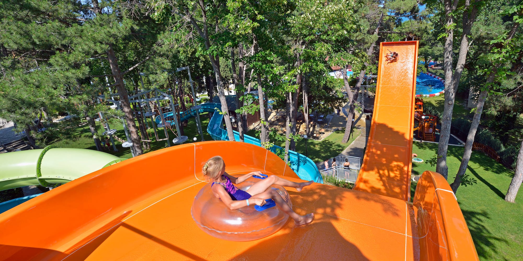 a girl in a swimsuit on an orange water slide