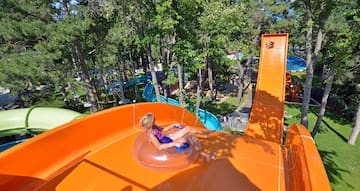 a girl in a swimsuit on an orange water slide