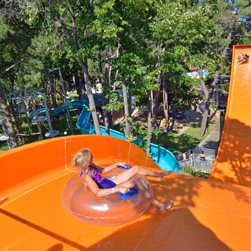 a girl in a swimsuit on an orange water slide