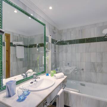 a bathroom with a mirror and a tub