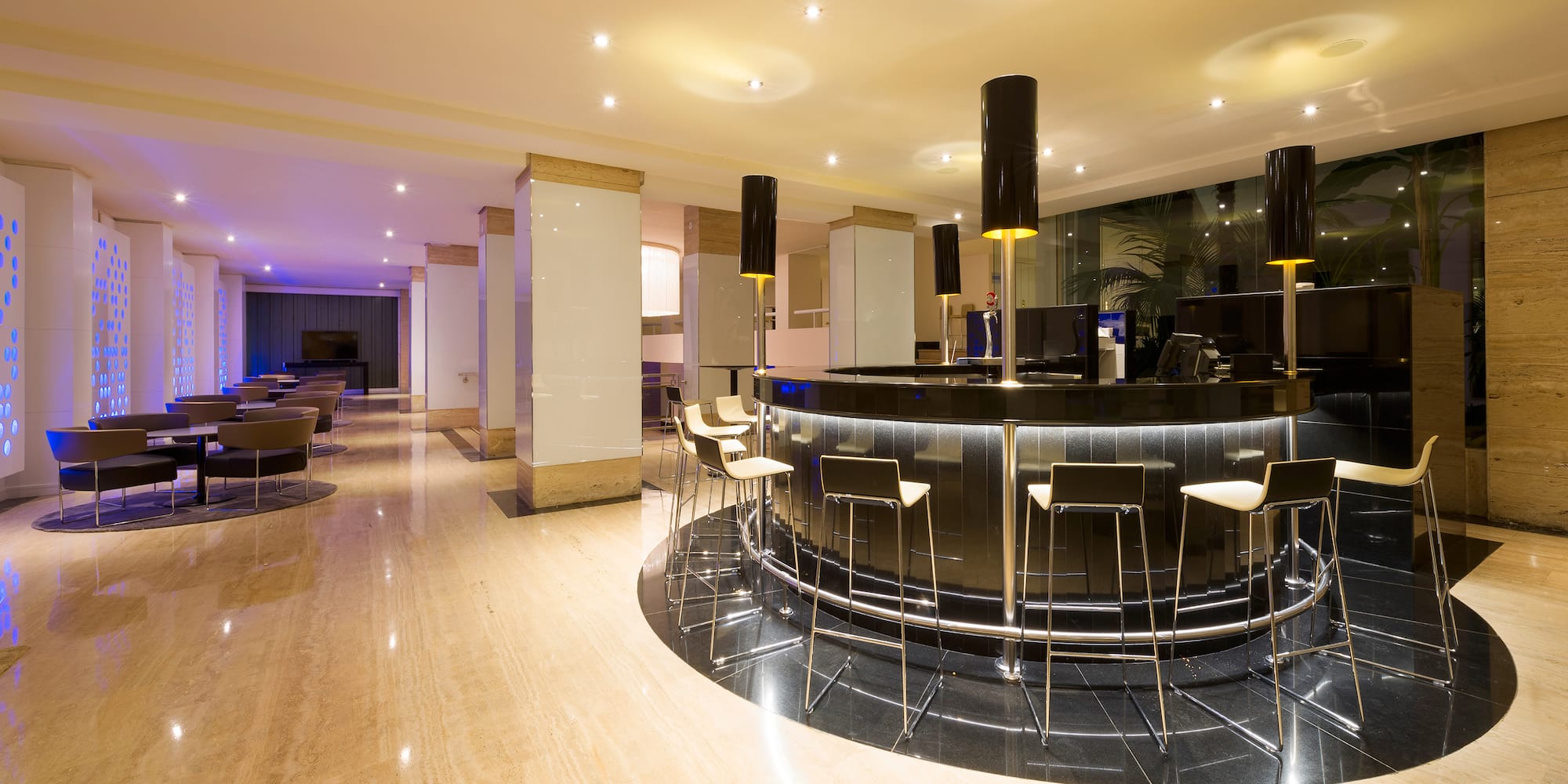 a room with a bar and chairs