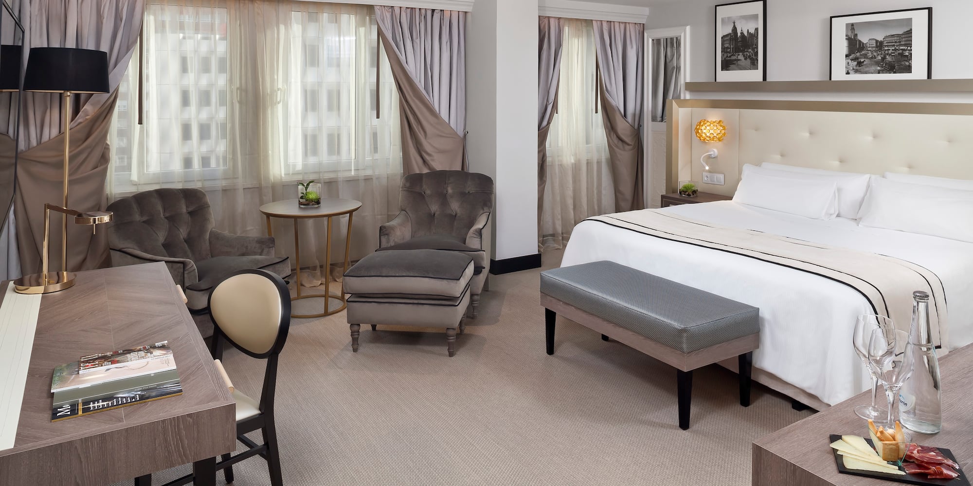 a room with a bed and chairs