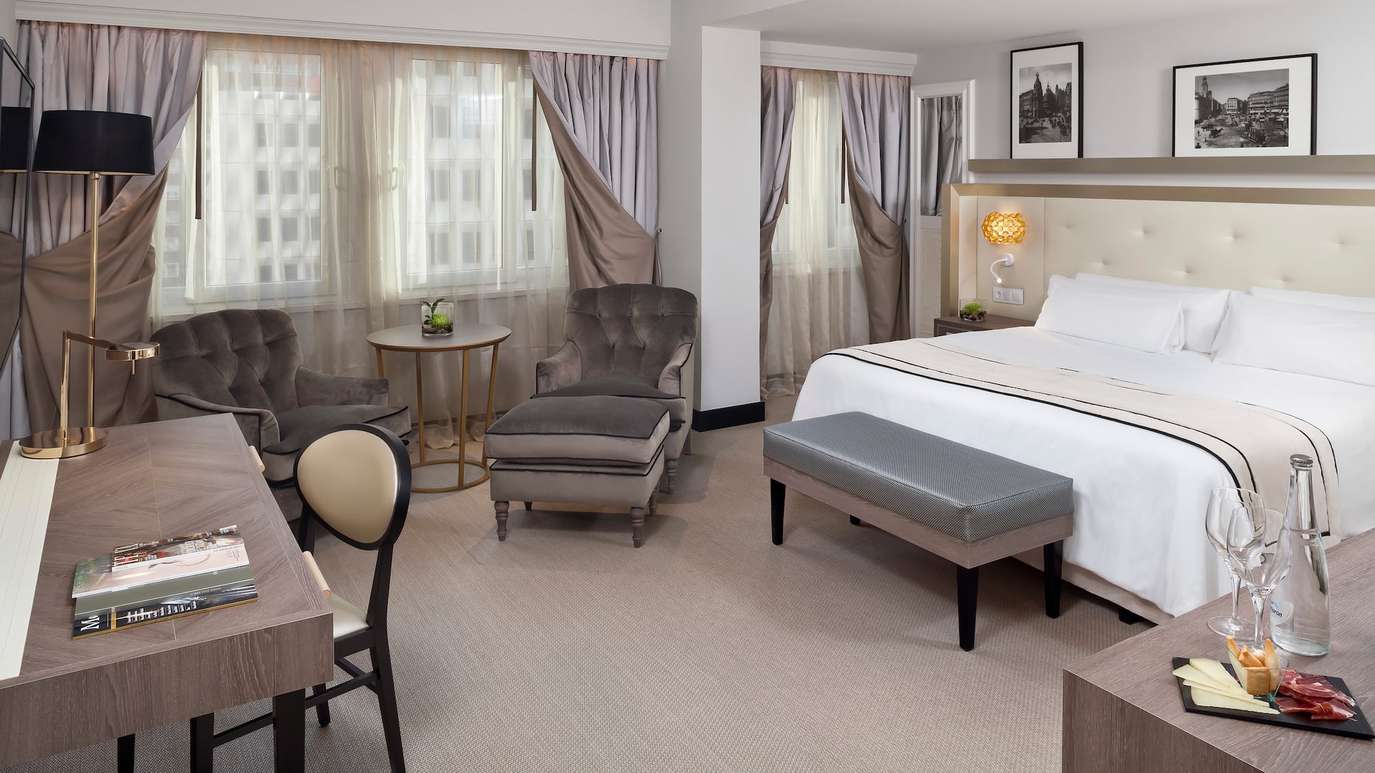 a room with a bed and chairs