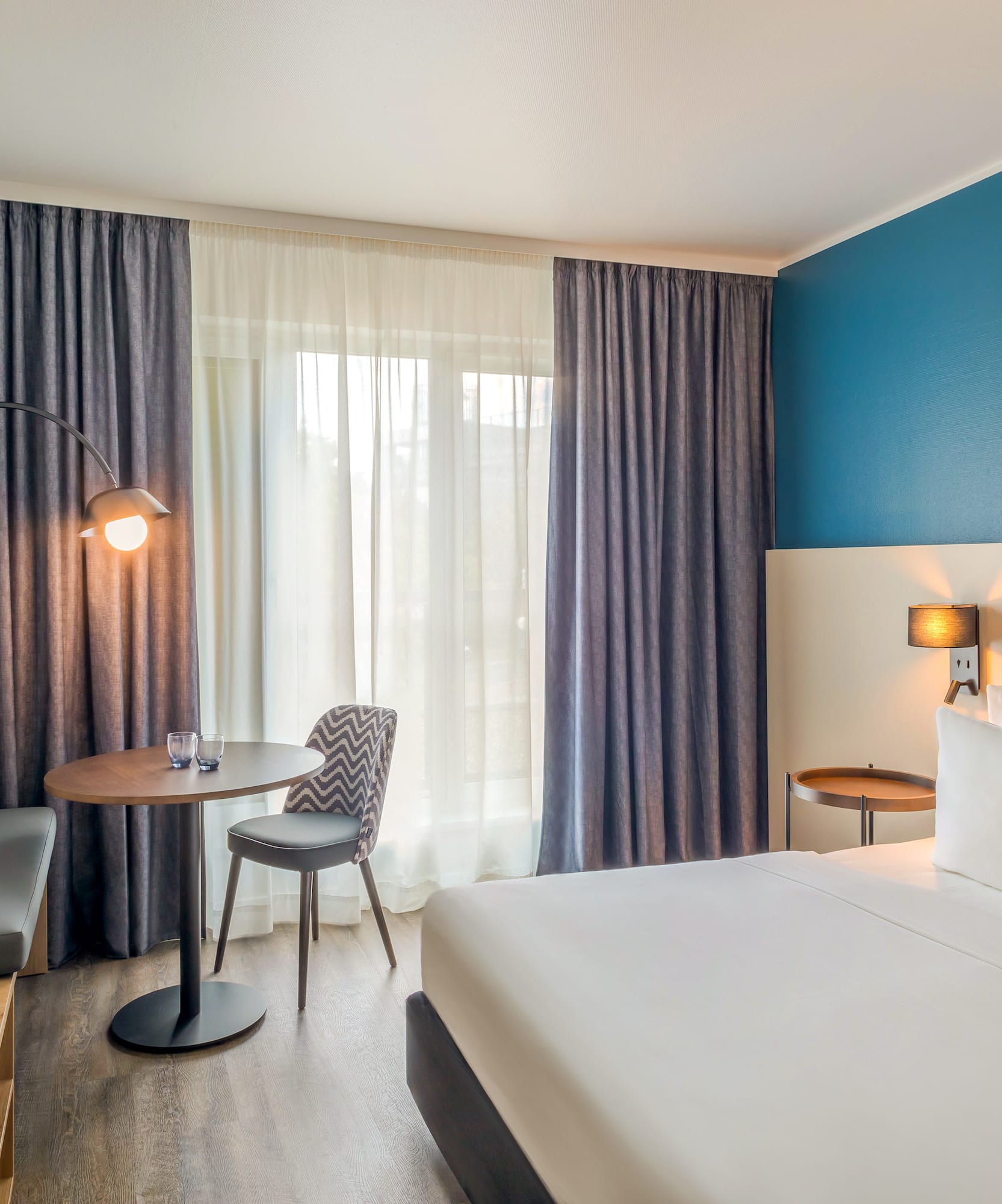 a room with a bed and a table and chairs