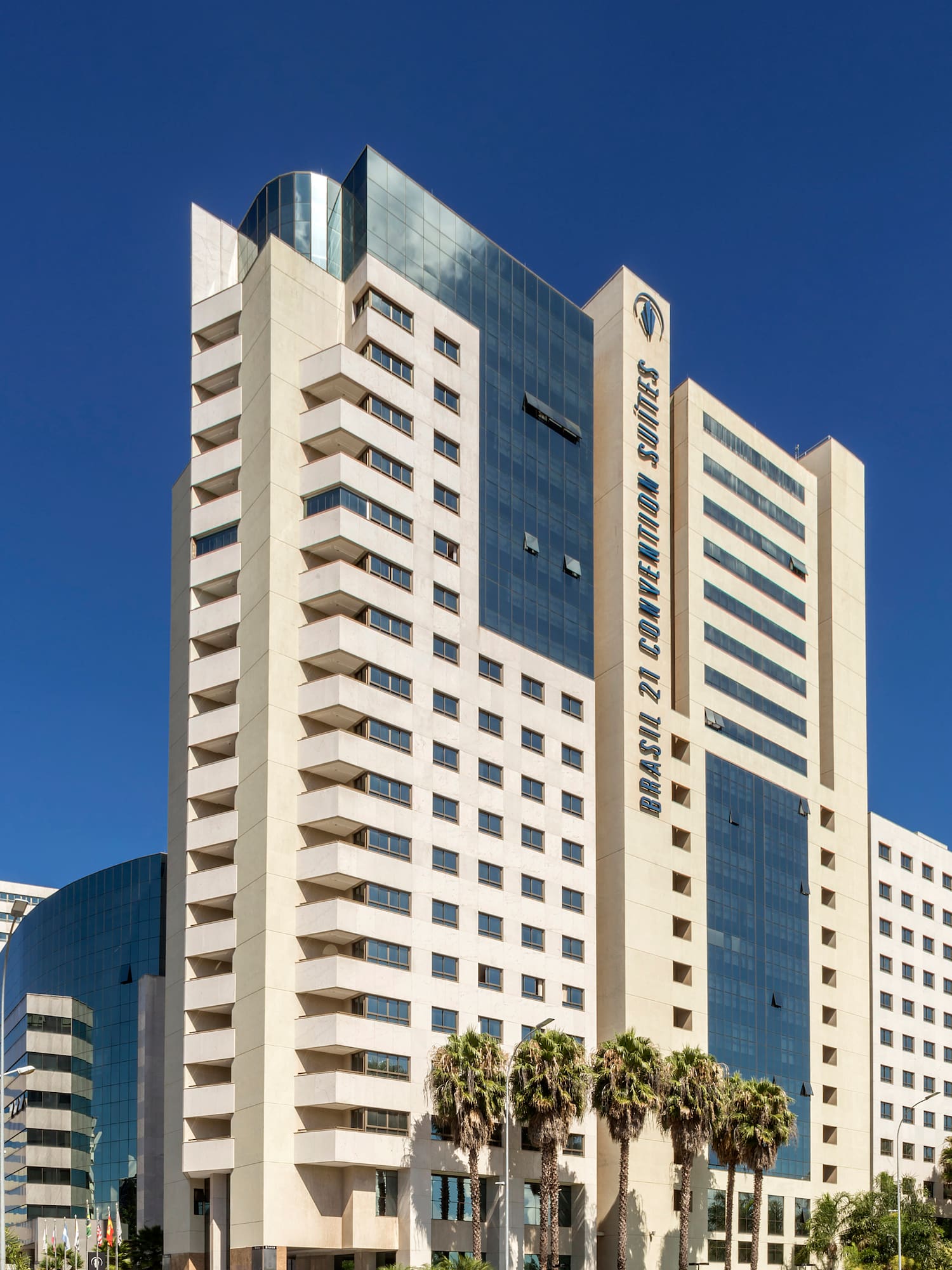 a tall white building with blue glass windows