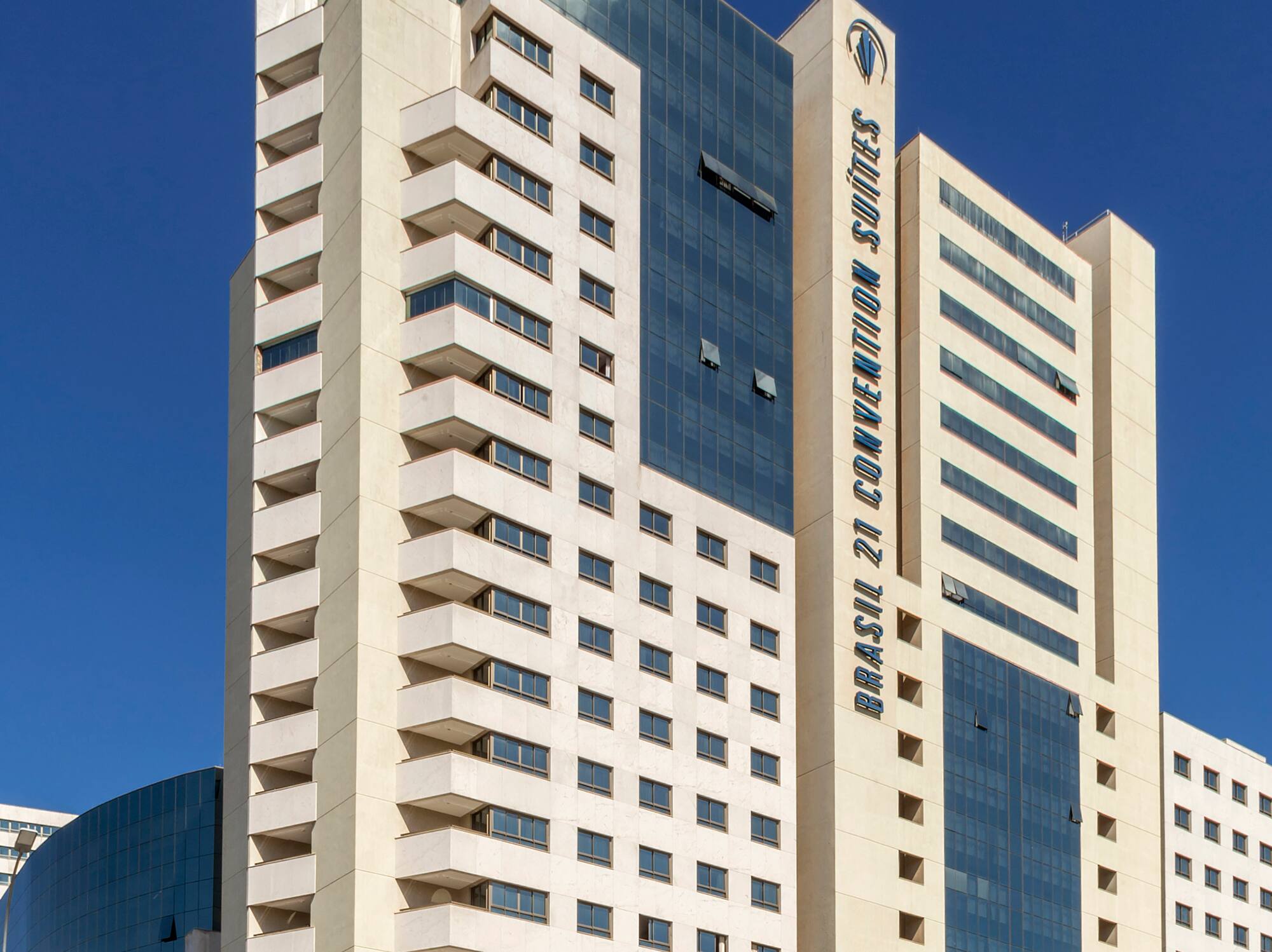 a tall white building with blue glass windows
