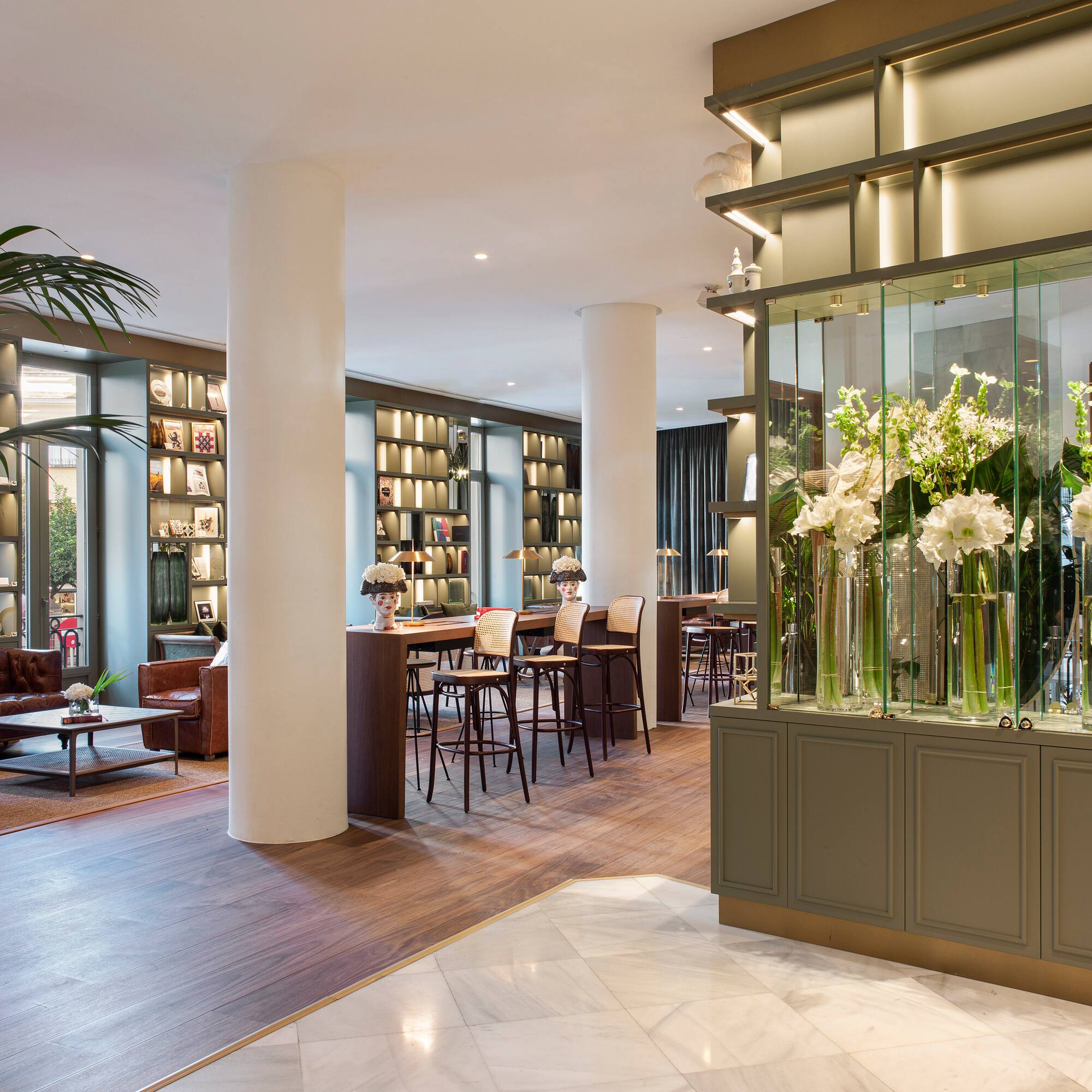 a room with a large glass display case with flowers in it