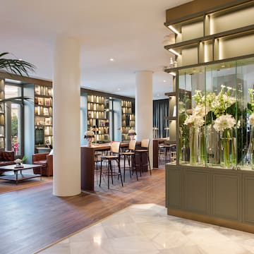 a room with a large glass display case with flowers in it