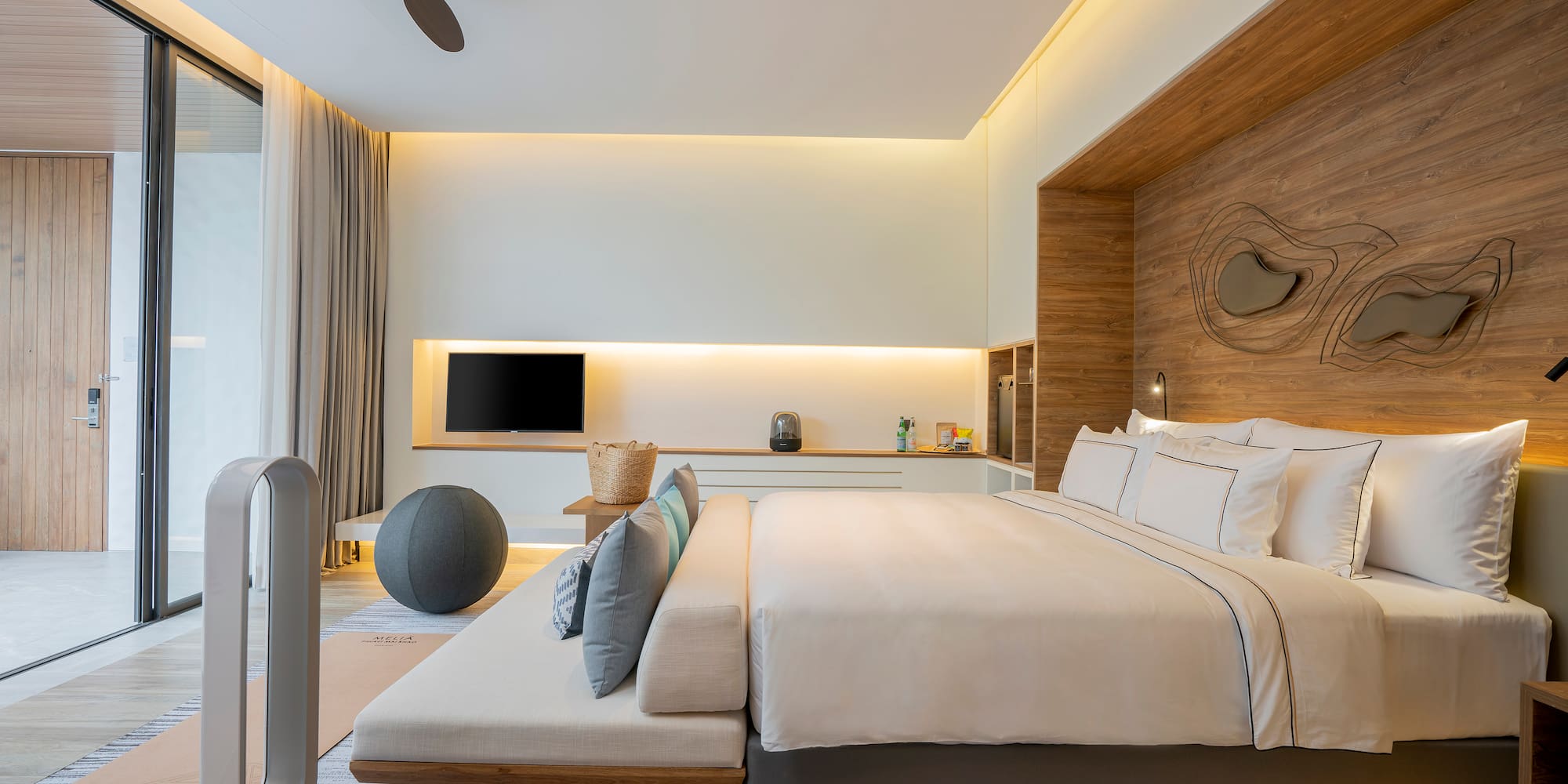 a room with a bed and a fan