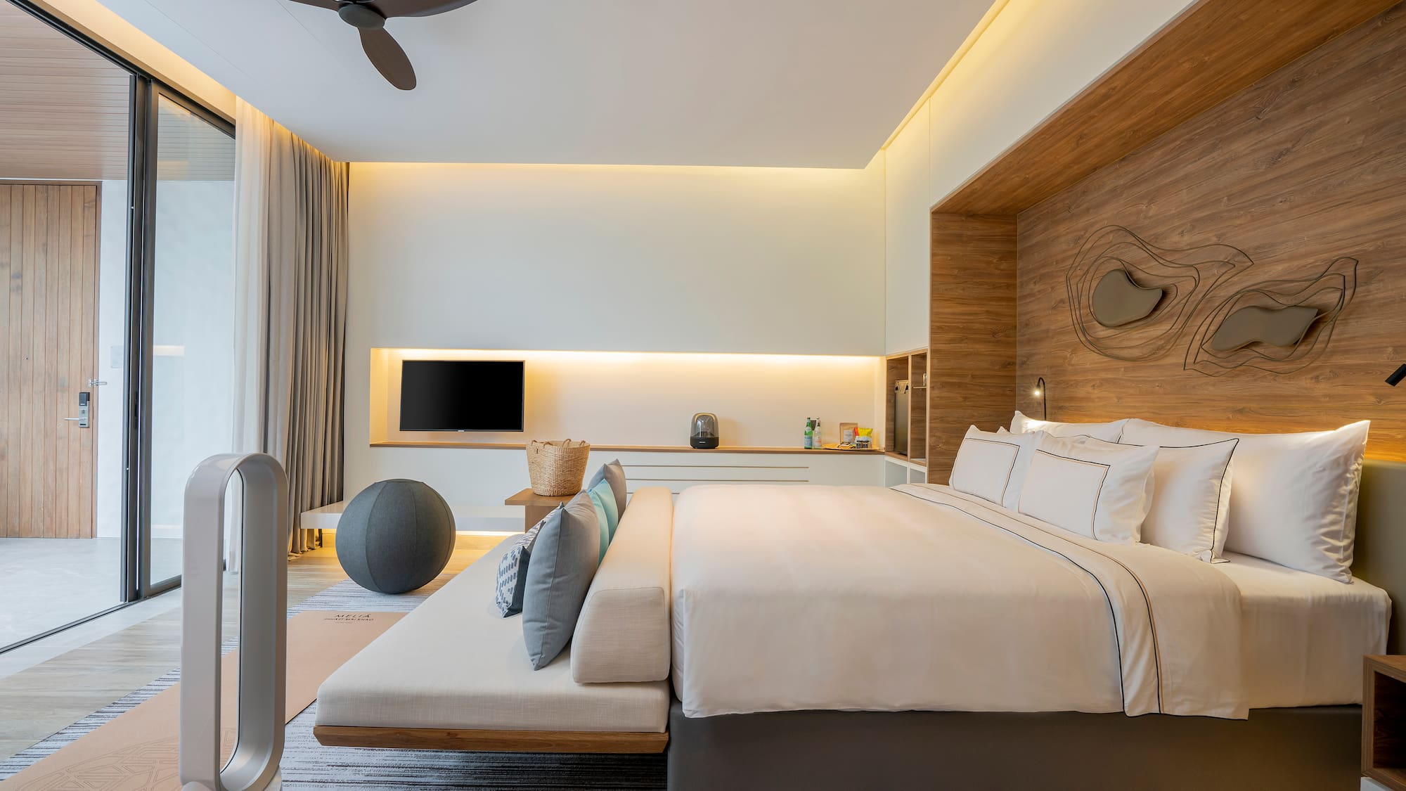 a room with a bed and a fan