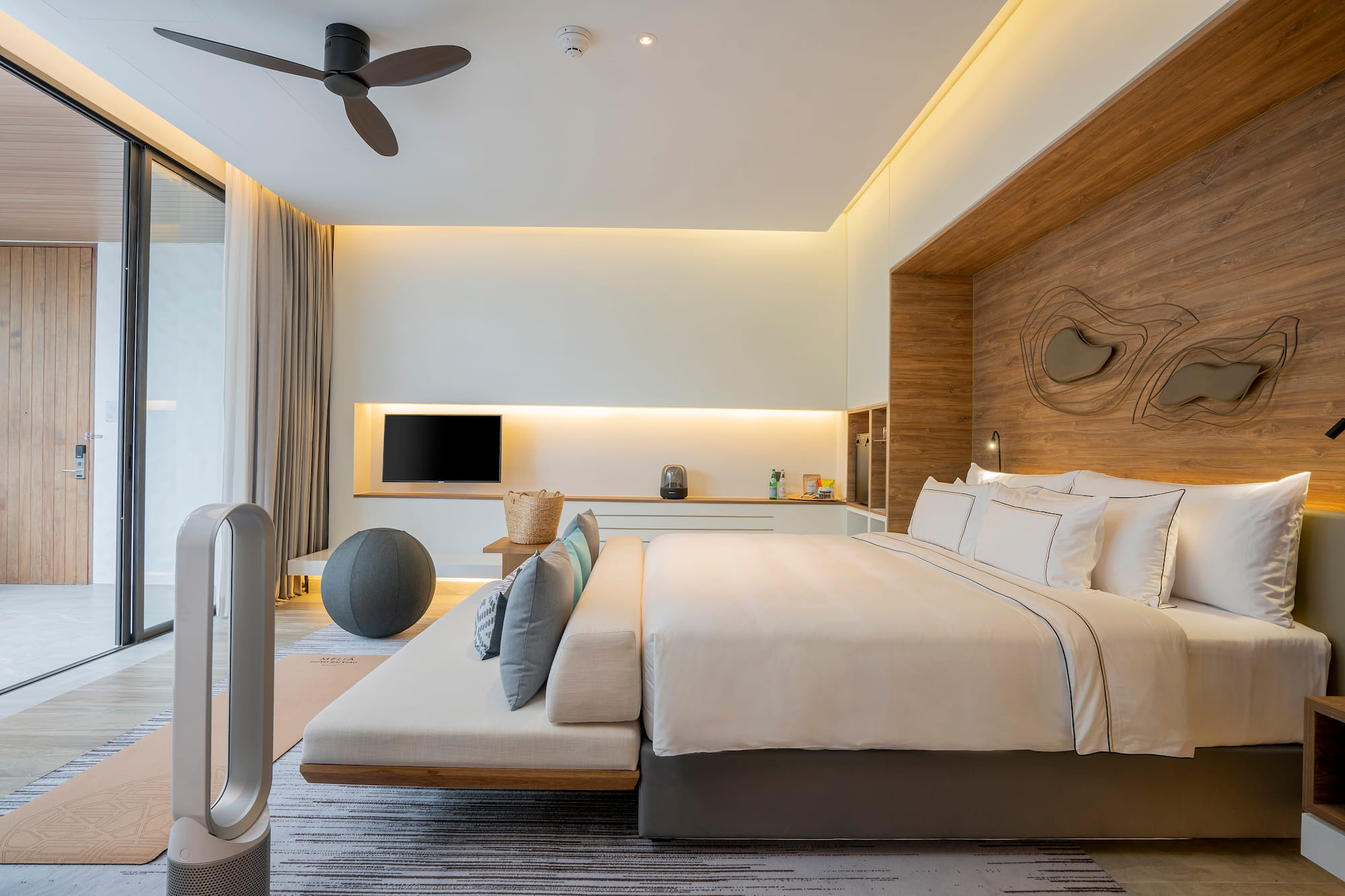 a room with a bed and a fan