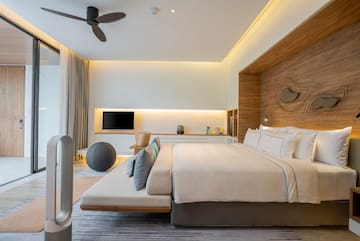 a room with a bed and a fan