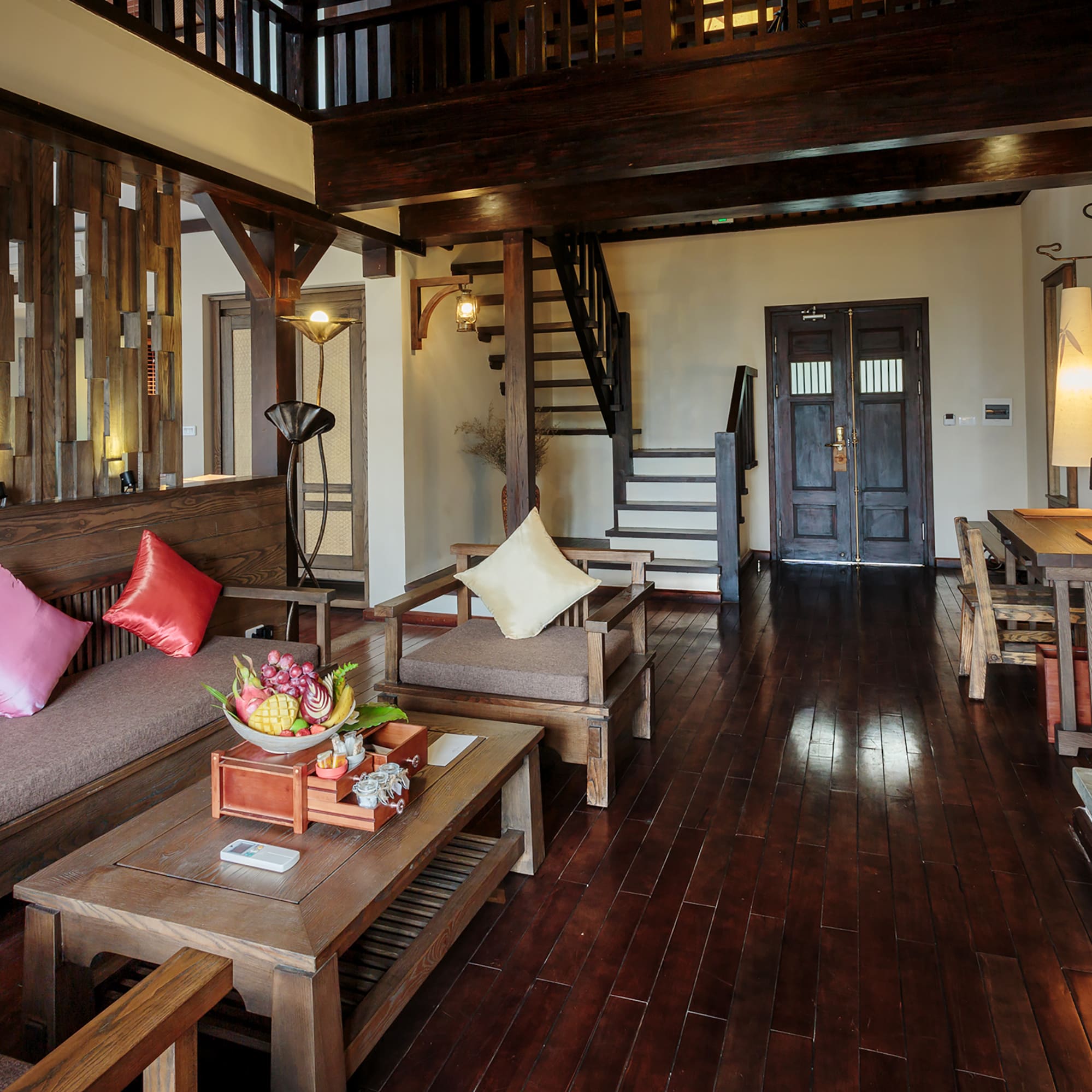 a living room with a wood floor and a staircase