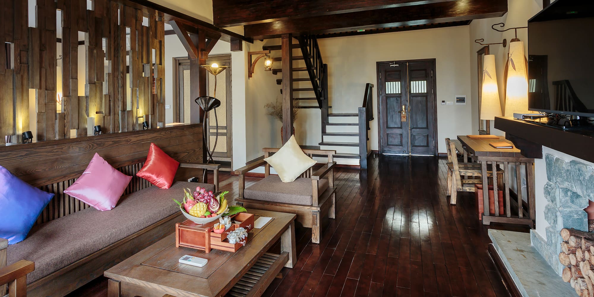 a living room with a wood floor and a staircase