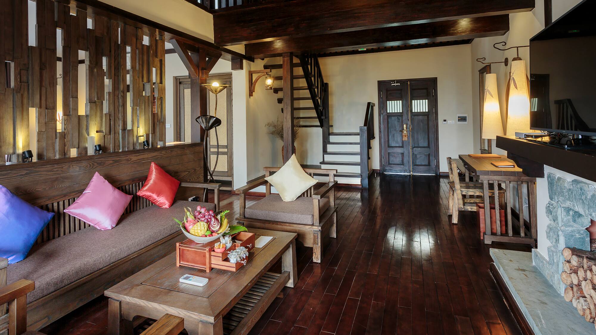 a living room with a wood floor and a staircase