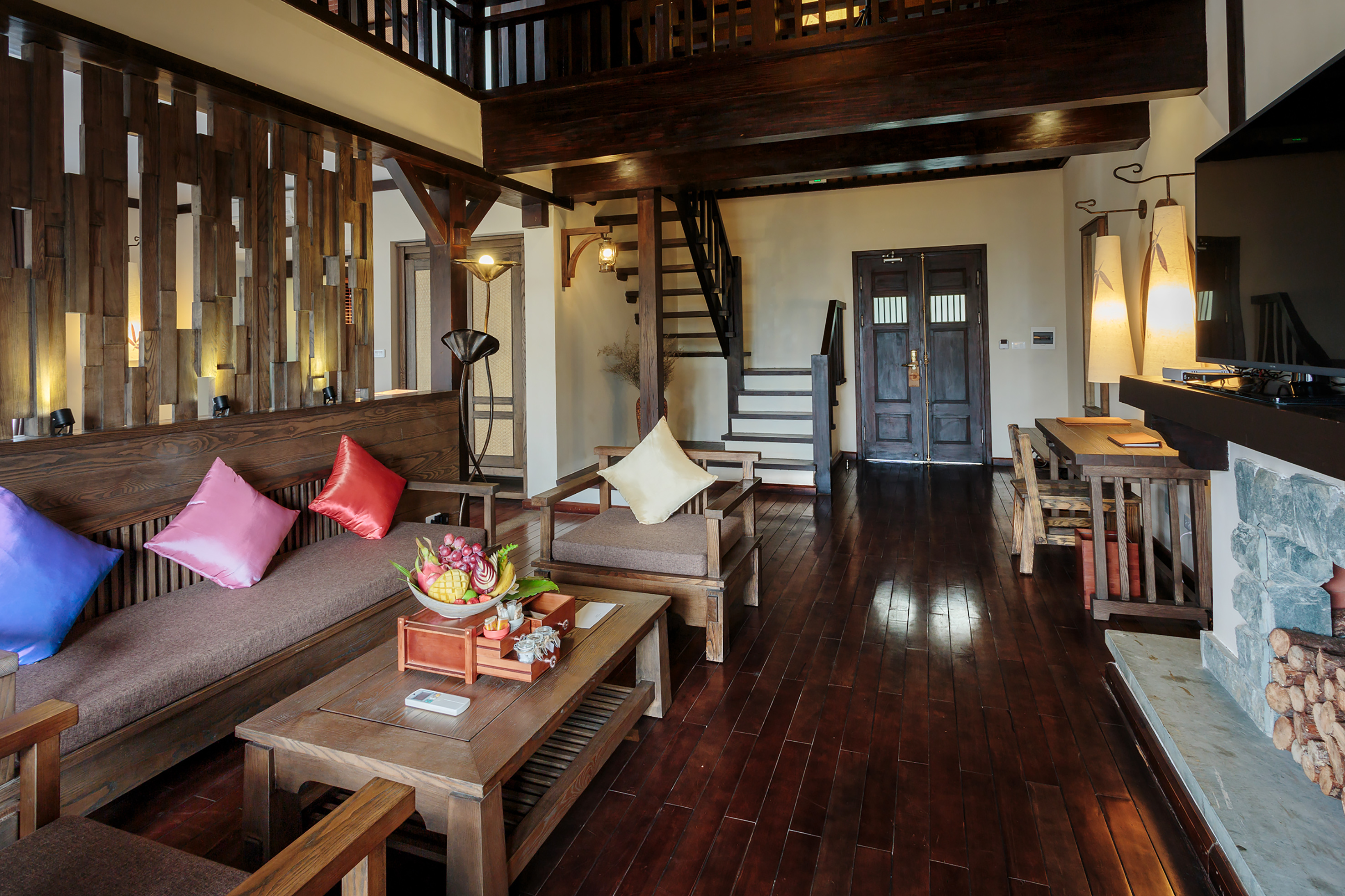 a living room with a wood floor and a staircase