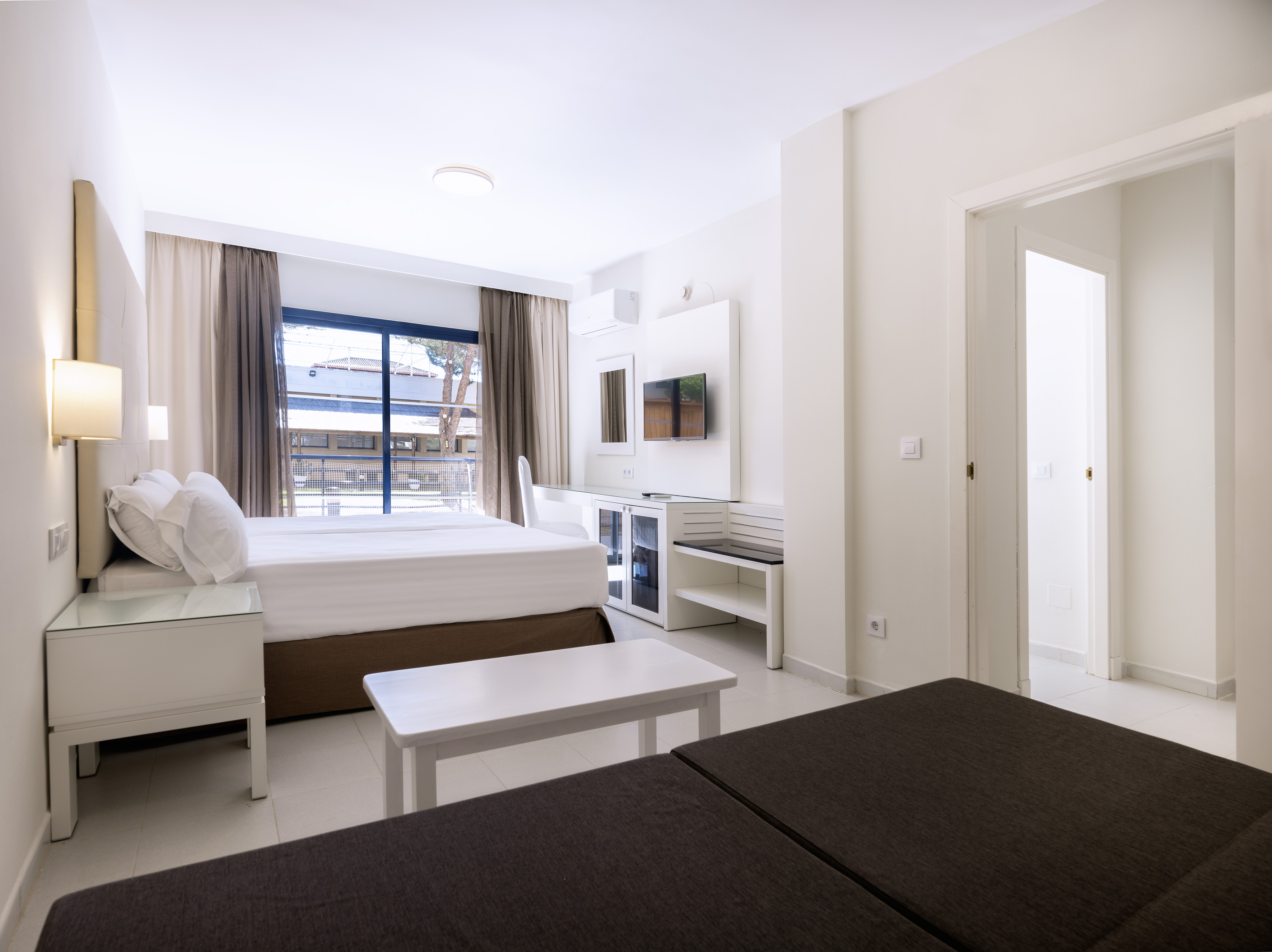 a room with a bed and a television