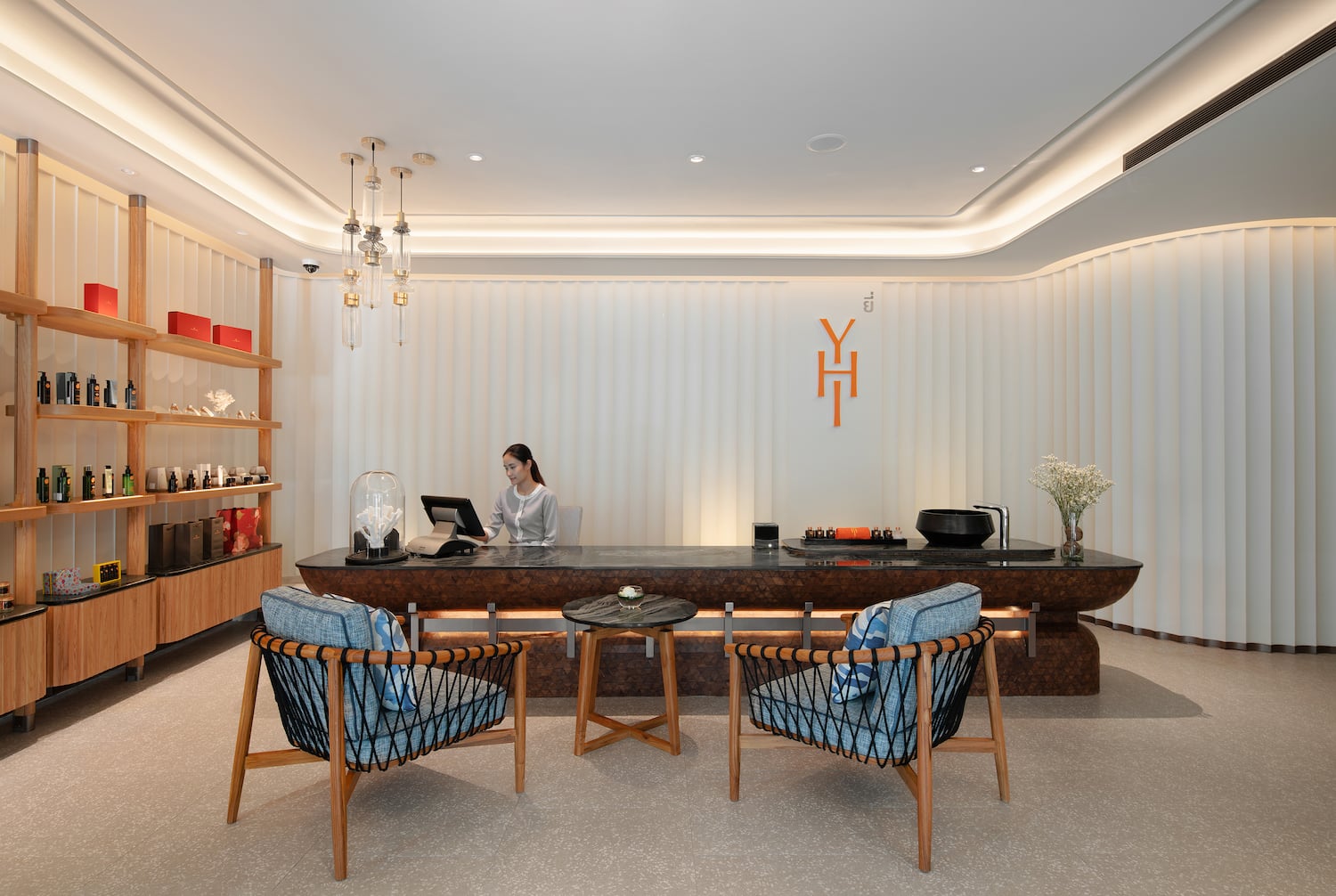 a woman sitting at a reception desk