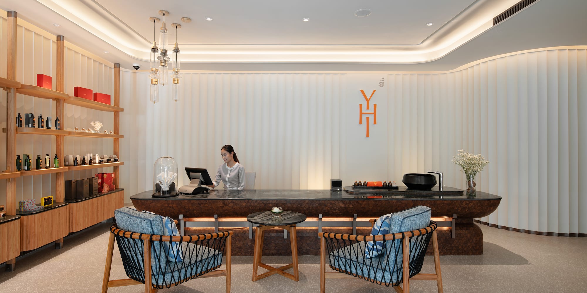 a woman sitting at a reception desk