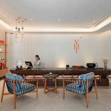 a woman sitting at a reception desk