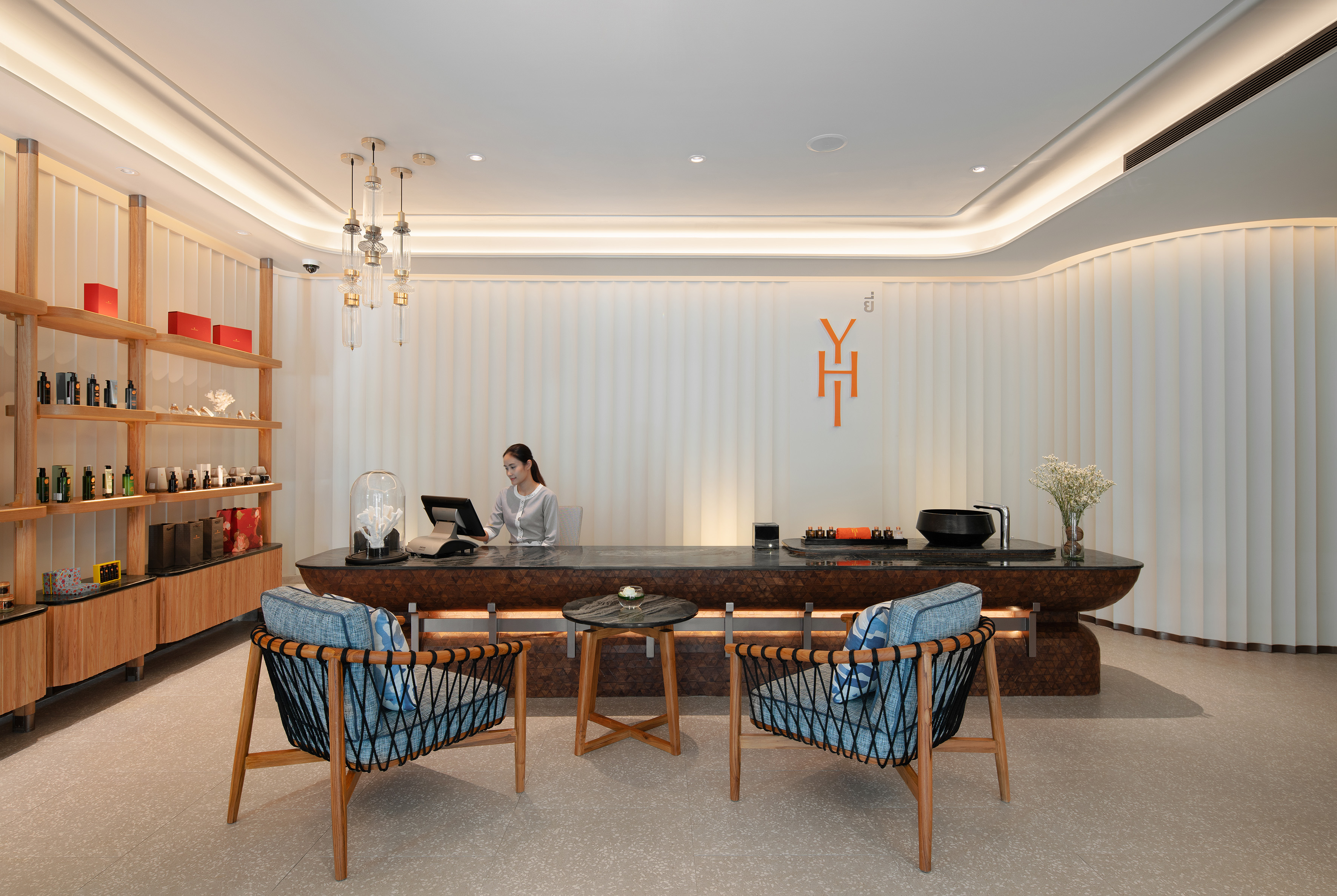 Modern reception area with attendant, product shelves, and stylish lounge seating.
